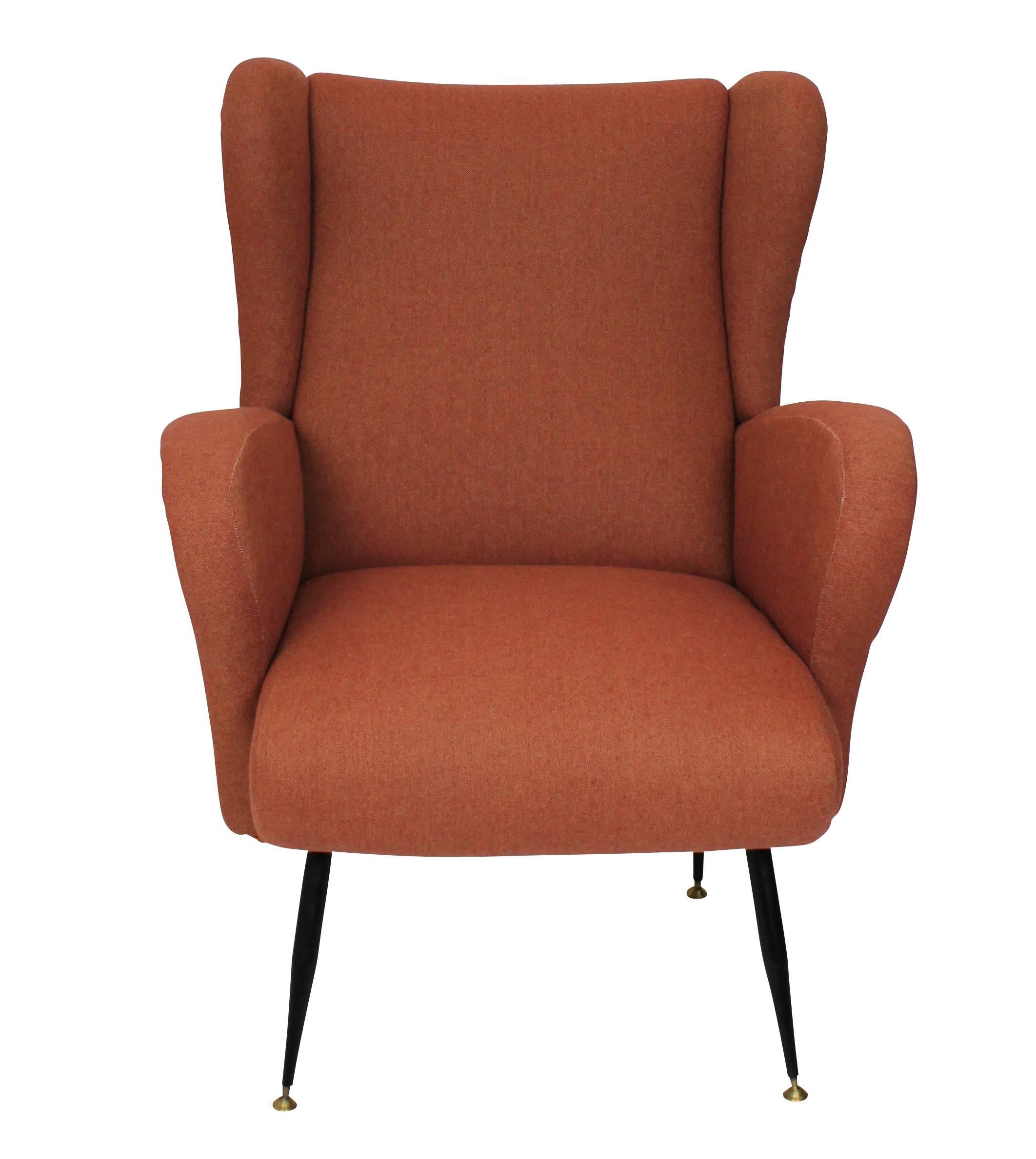 A pair of Italian armchairs of comfortable design, newly upholstered and on metal tapering legs.