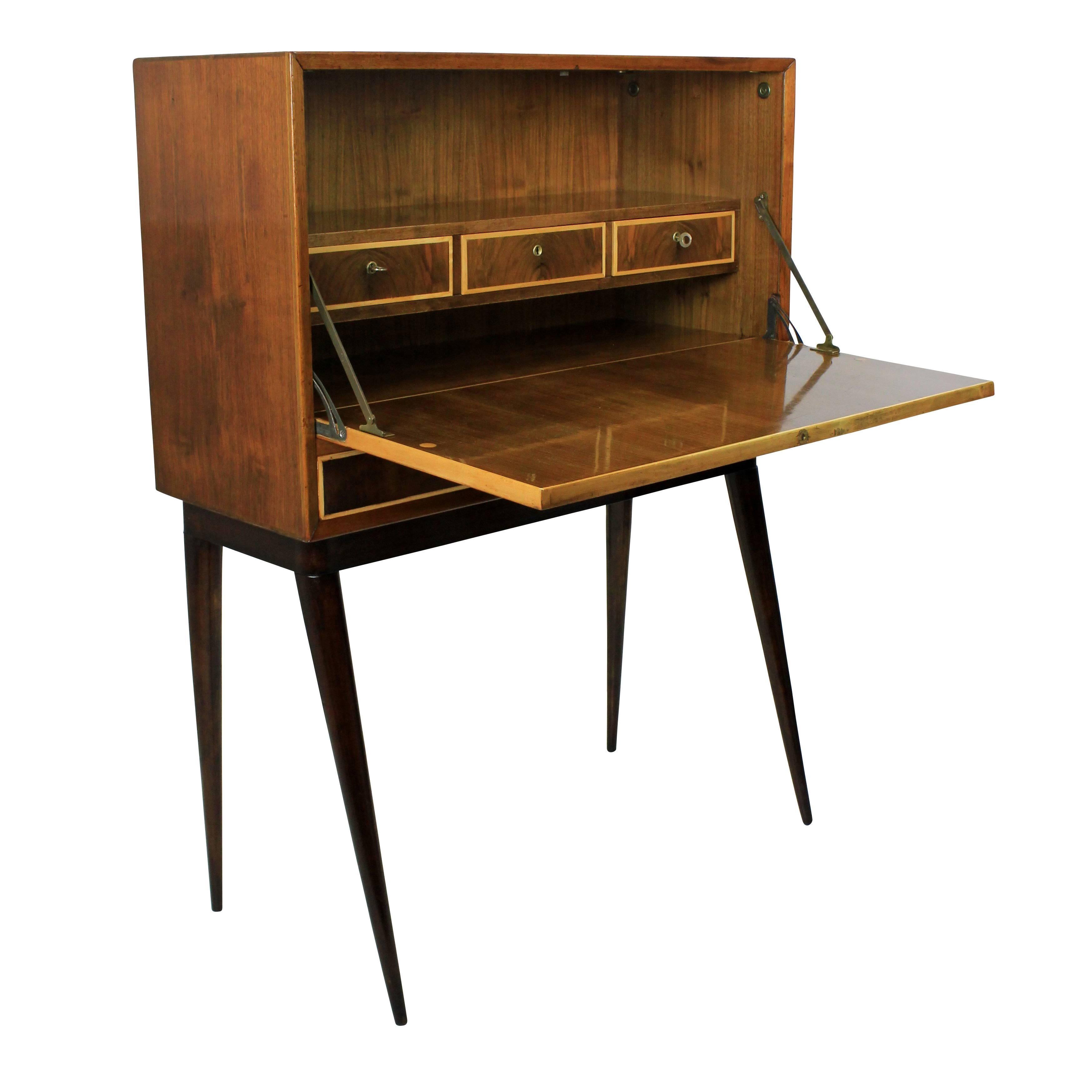 An Italian cabinet of stylish design, with a fall front with drawers inside and two drawers beneath: all with their own key.
