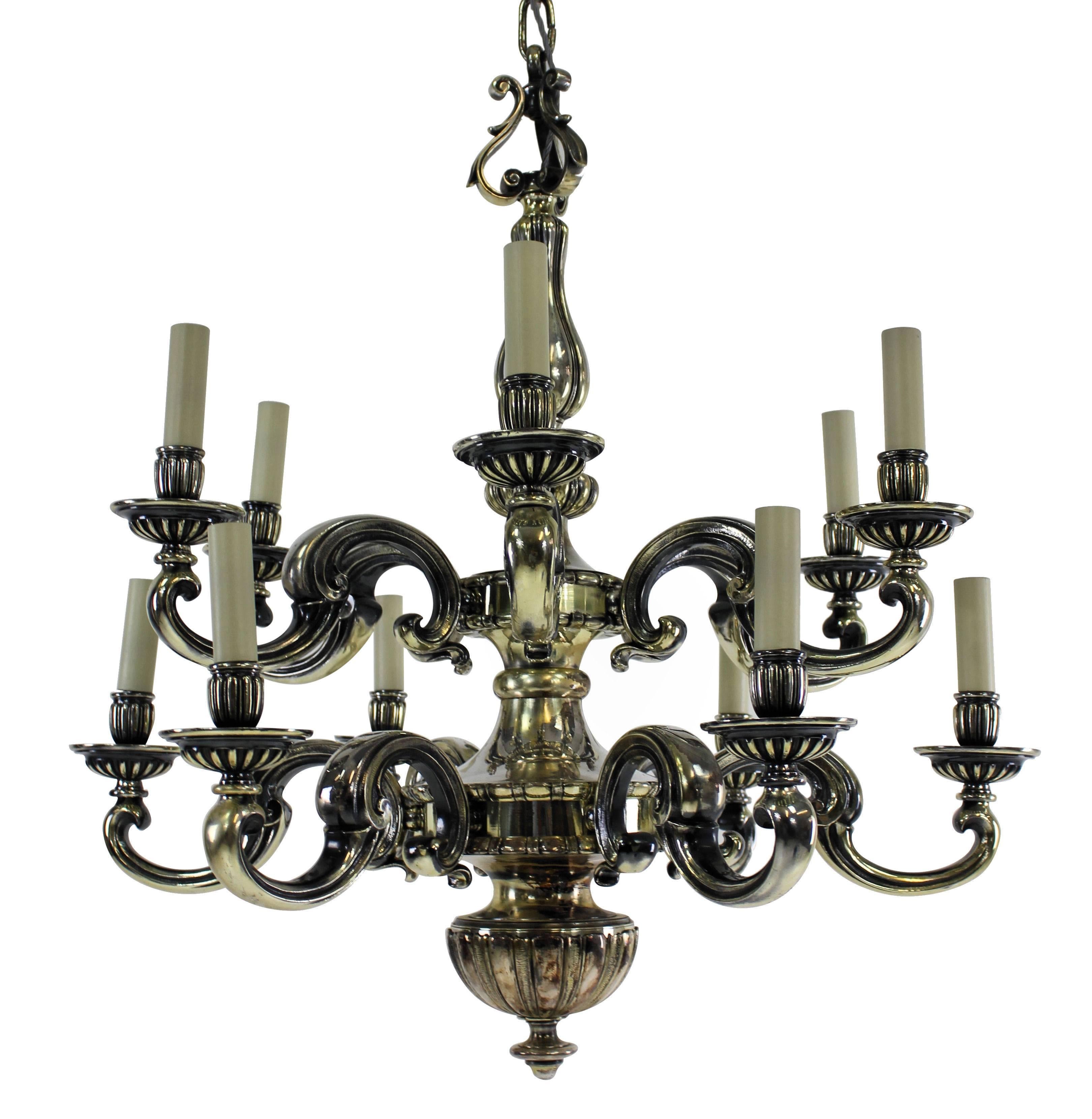 An English silver plated bronze chandelier of fine quality in the Charles II Style comprising two tiers and twelve lights in total.

Newly electrified.