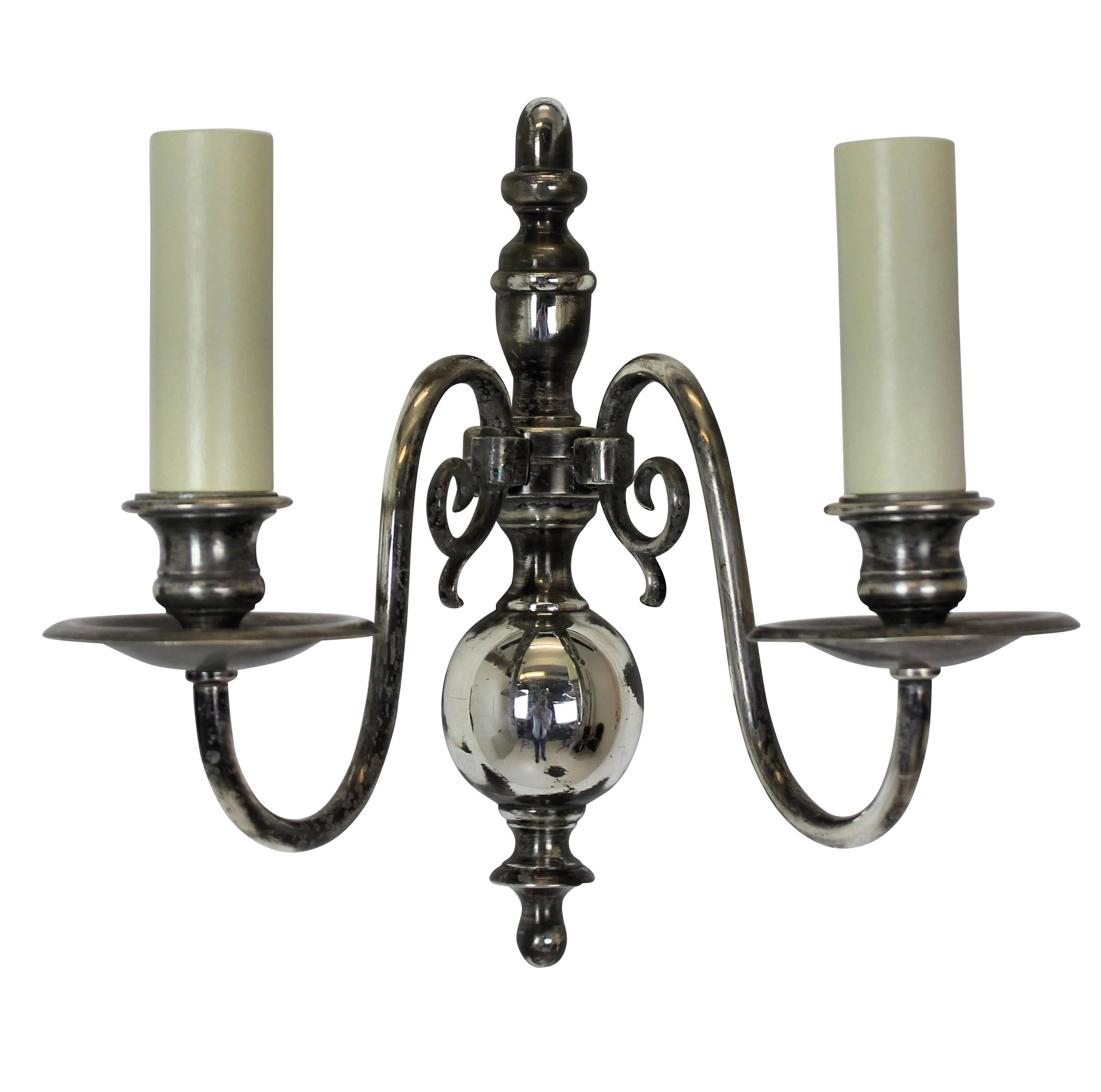 A set of four Flemish silver plated twin branch wall sconces.