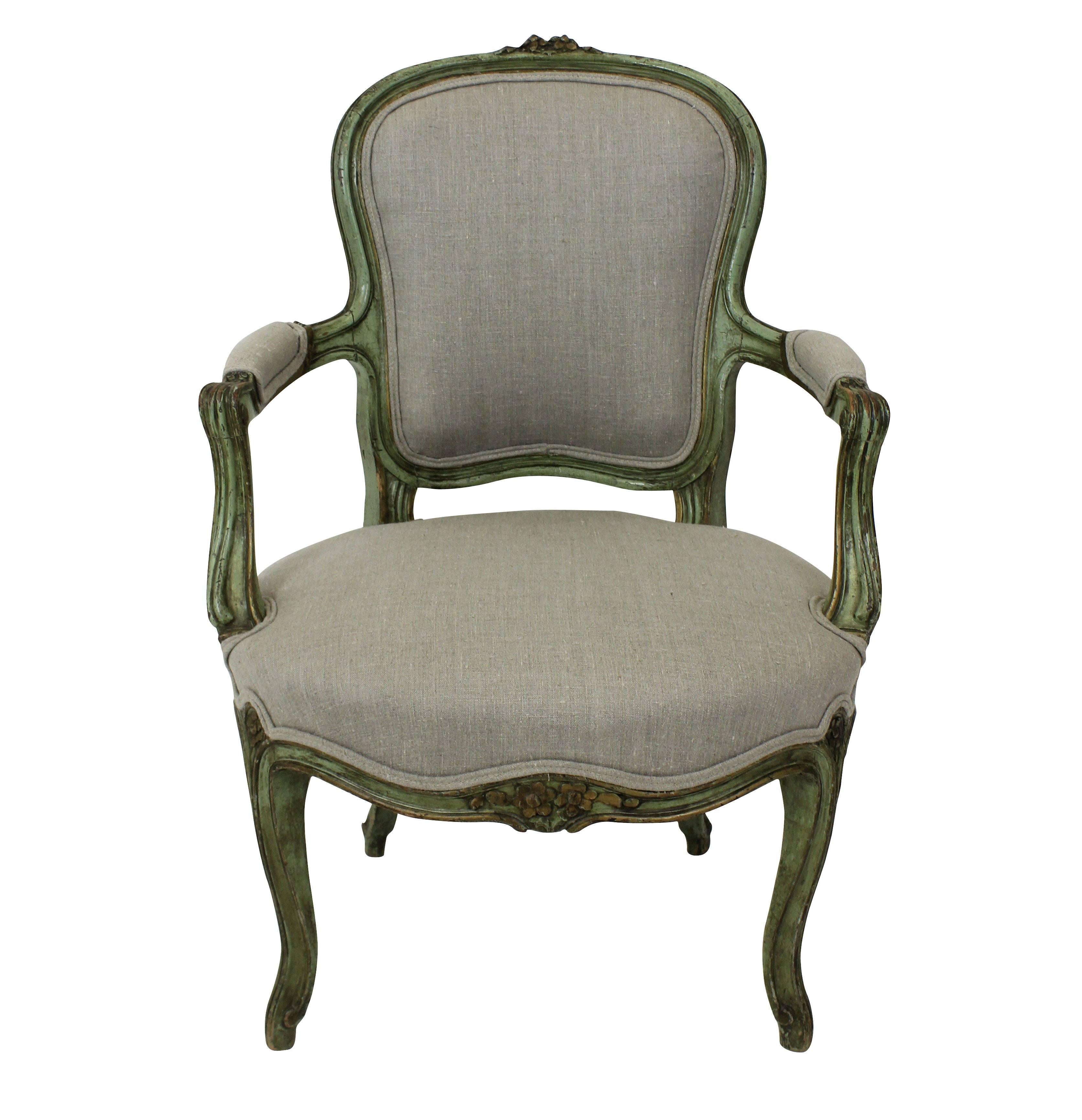 A pair of French open armchairs in their original eau de nil paint. Newly upholstered in natural linen.