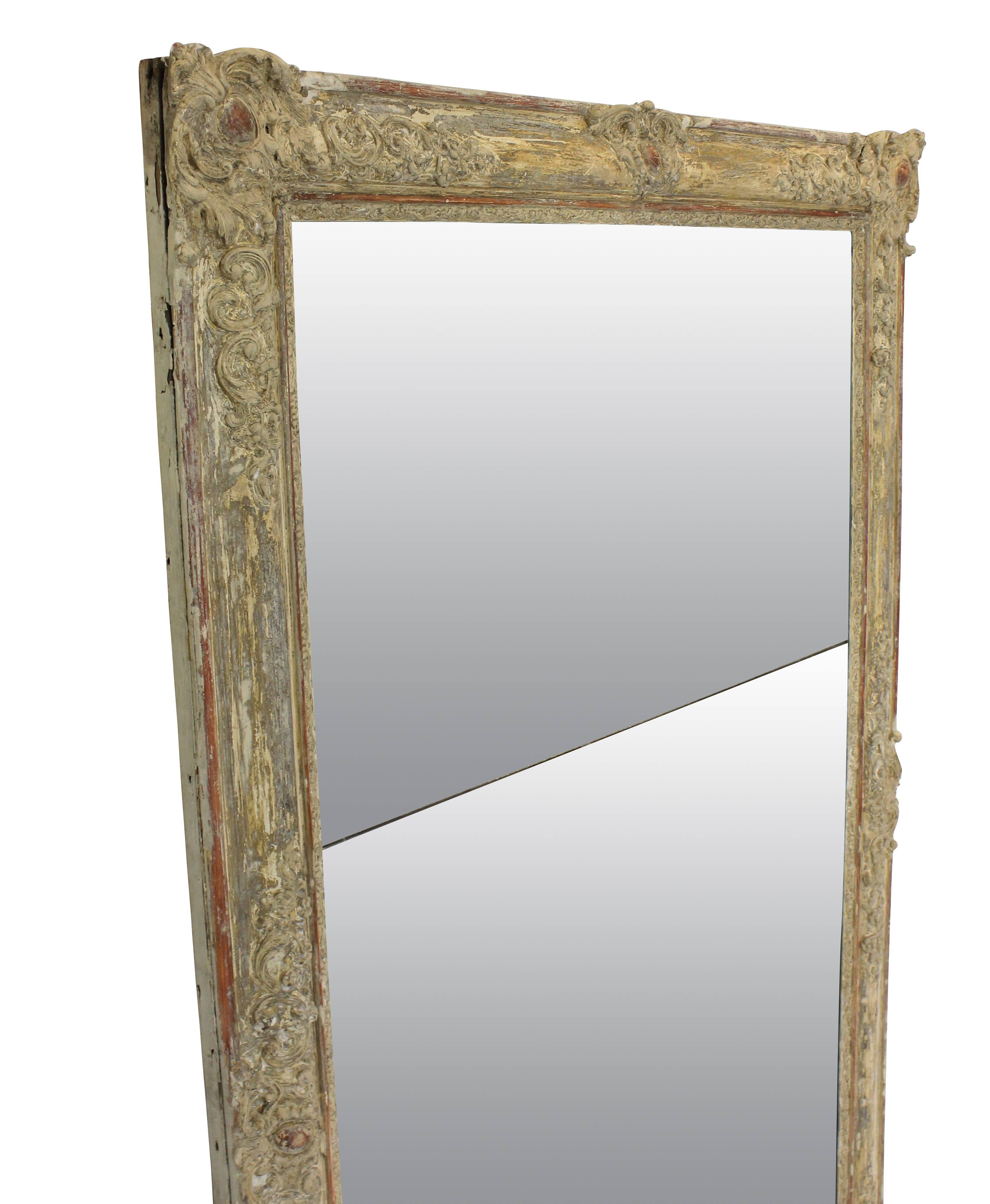 A late 18th century French over-mantle mirror, in its original distressed paints, with the original split mercury glass mirror plate.
    