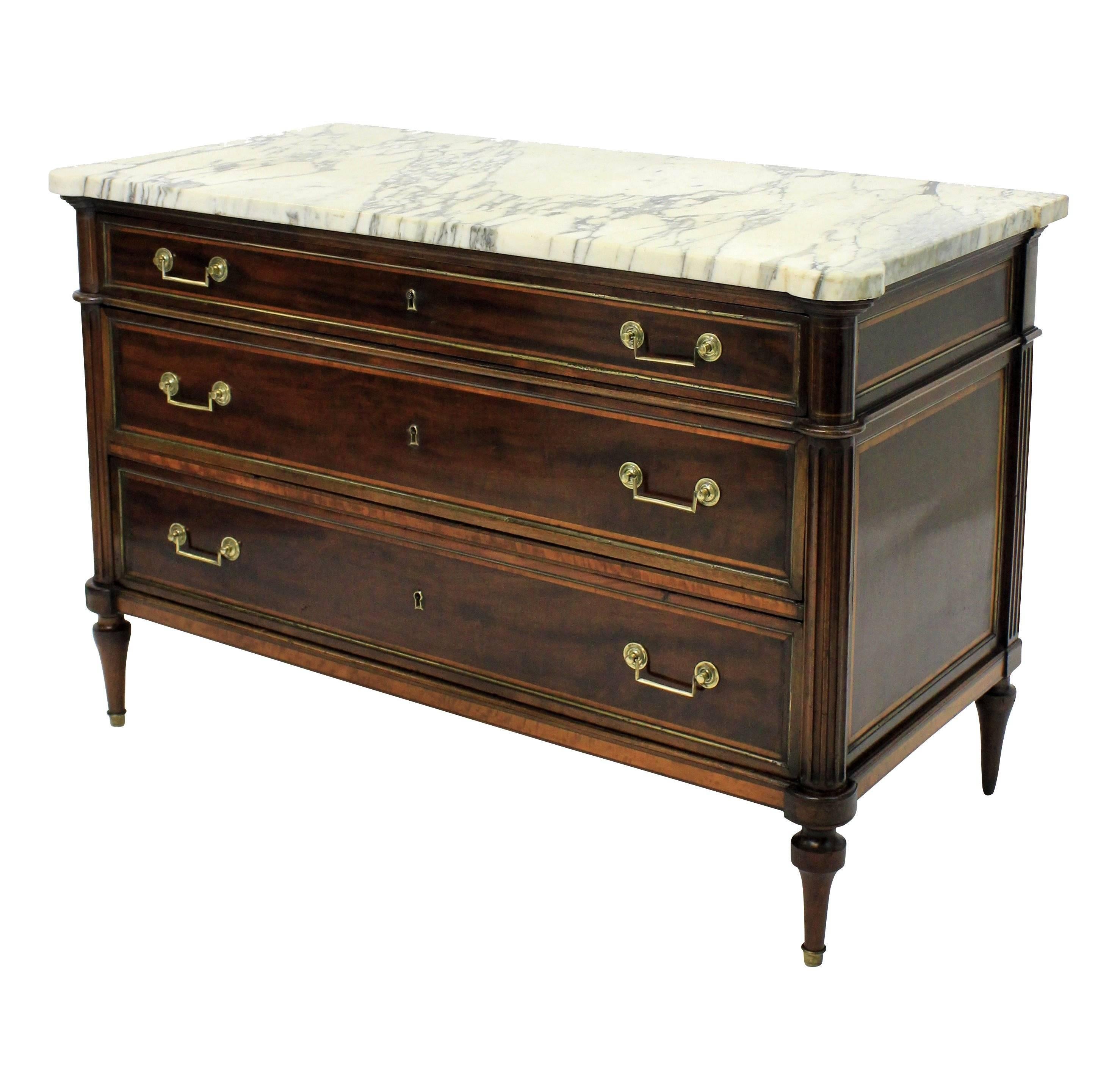 A fine French Directoire commode in mahogany with king wood borders. Brass inlay throughout, with it's original handles, sabot feet and stunning shaped marble top.
  