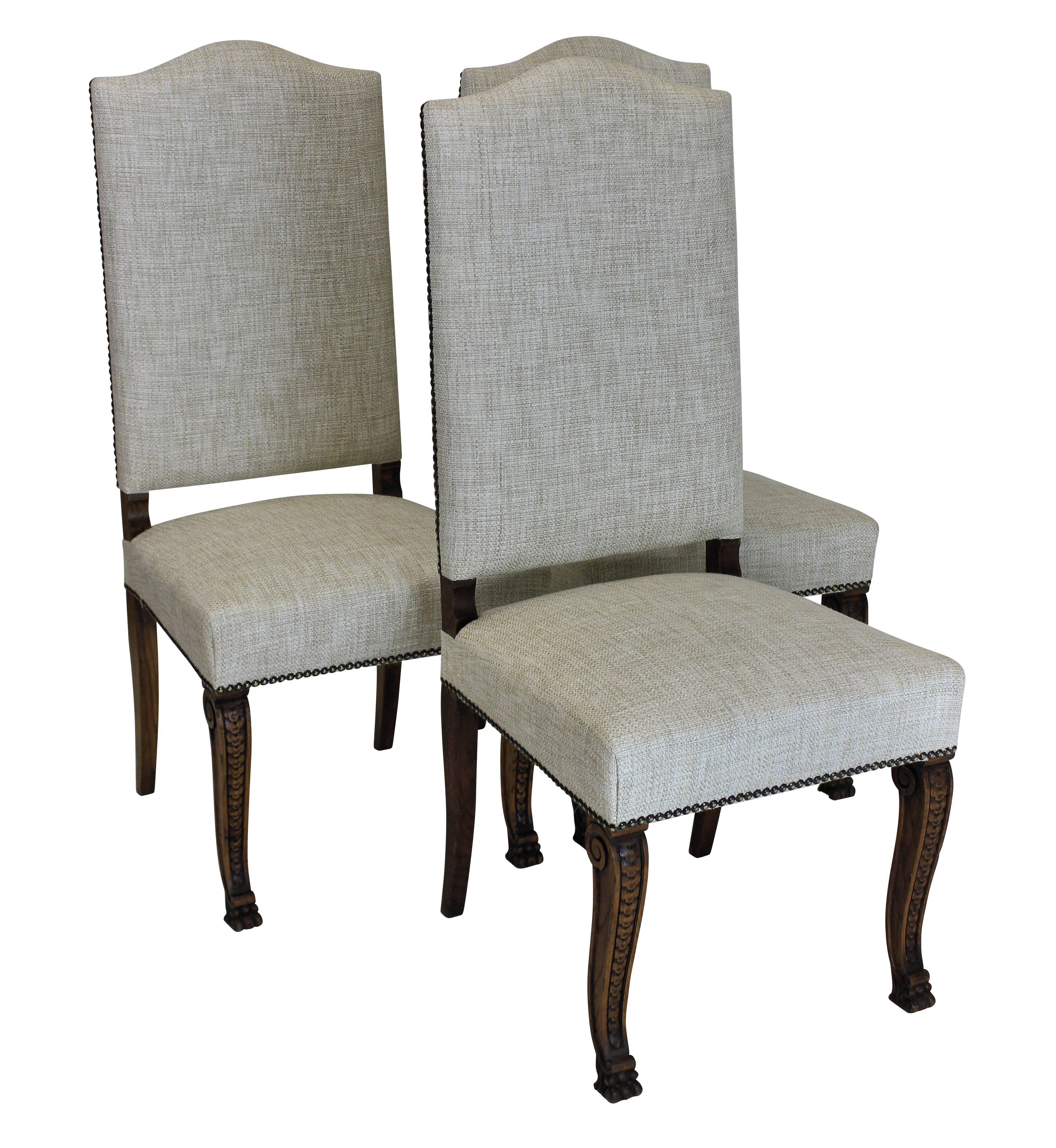 A set of six French high back dining chairs with beautifully carved walnut scrolled legs. Newly upholstered in a textured cream fabric with studding.
    