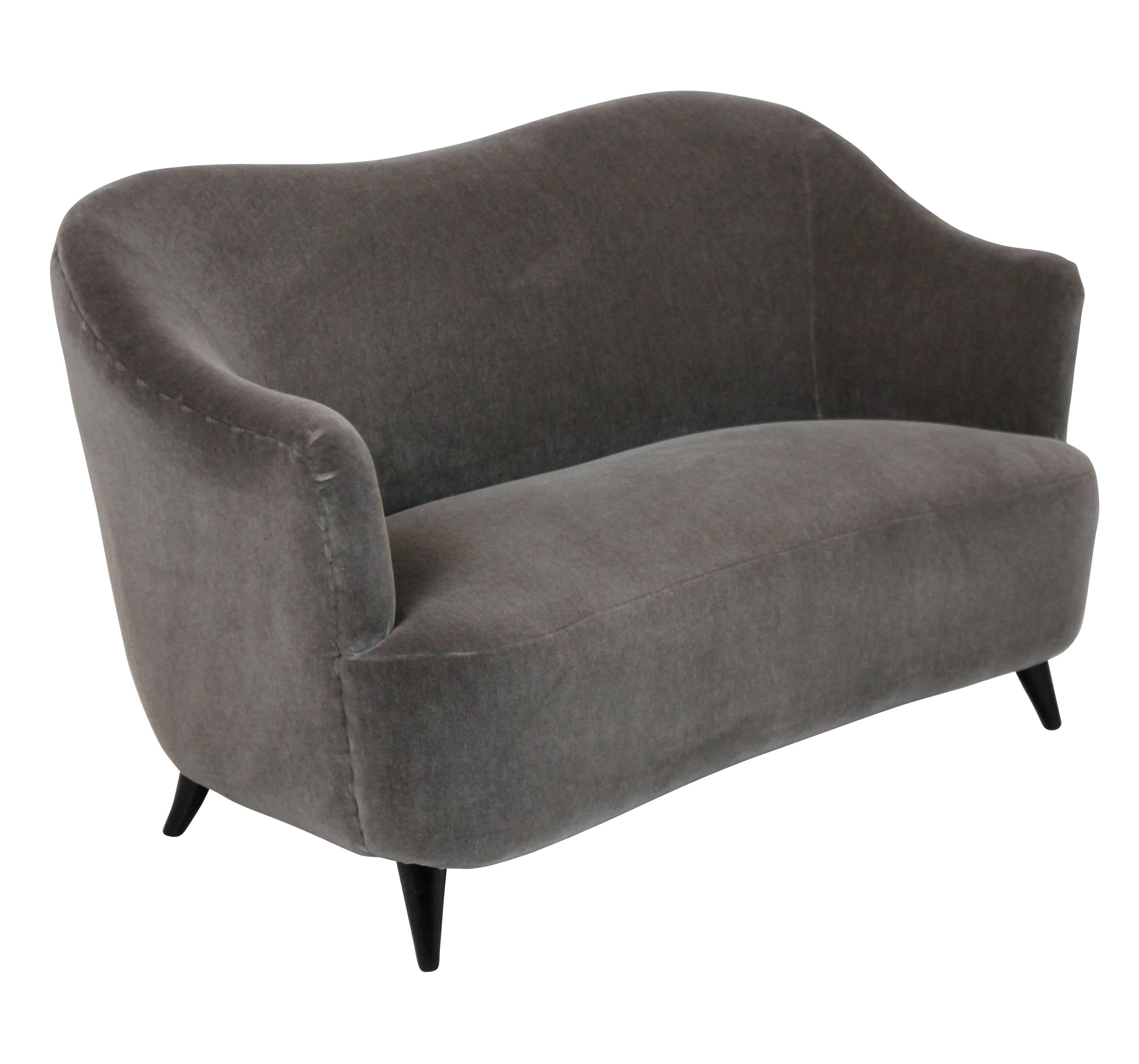 A sculptural Italian two set sofa with ebonized legs and newly upholstered in Donghia of NY mohair velvet.