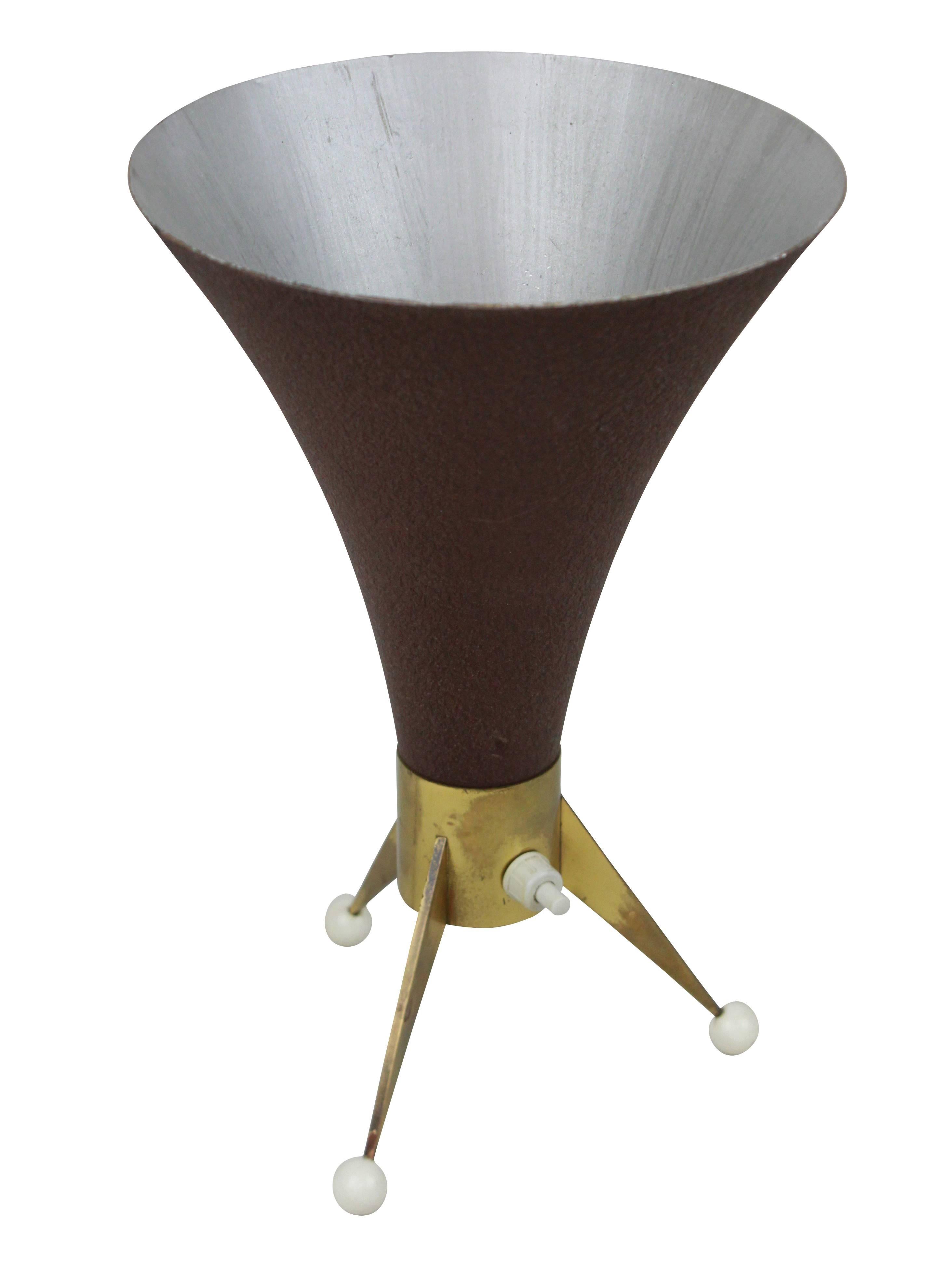 A stylish Italian desk lamp on a triform brass base with a conical uplighter.
