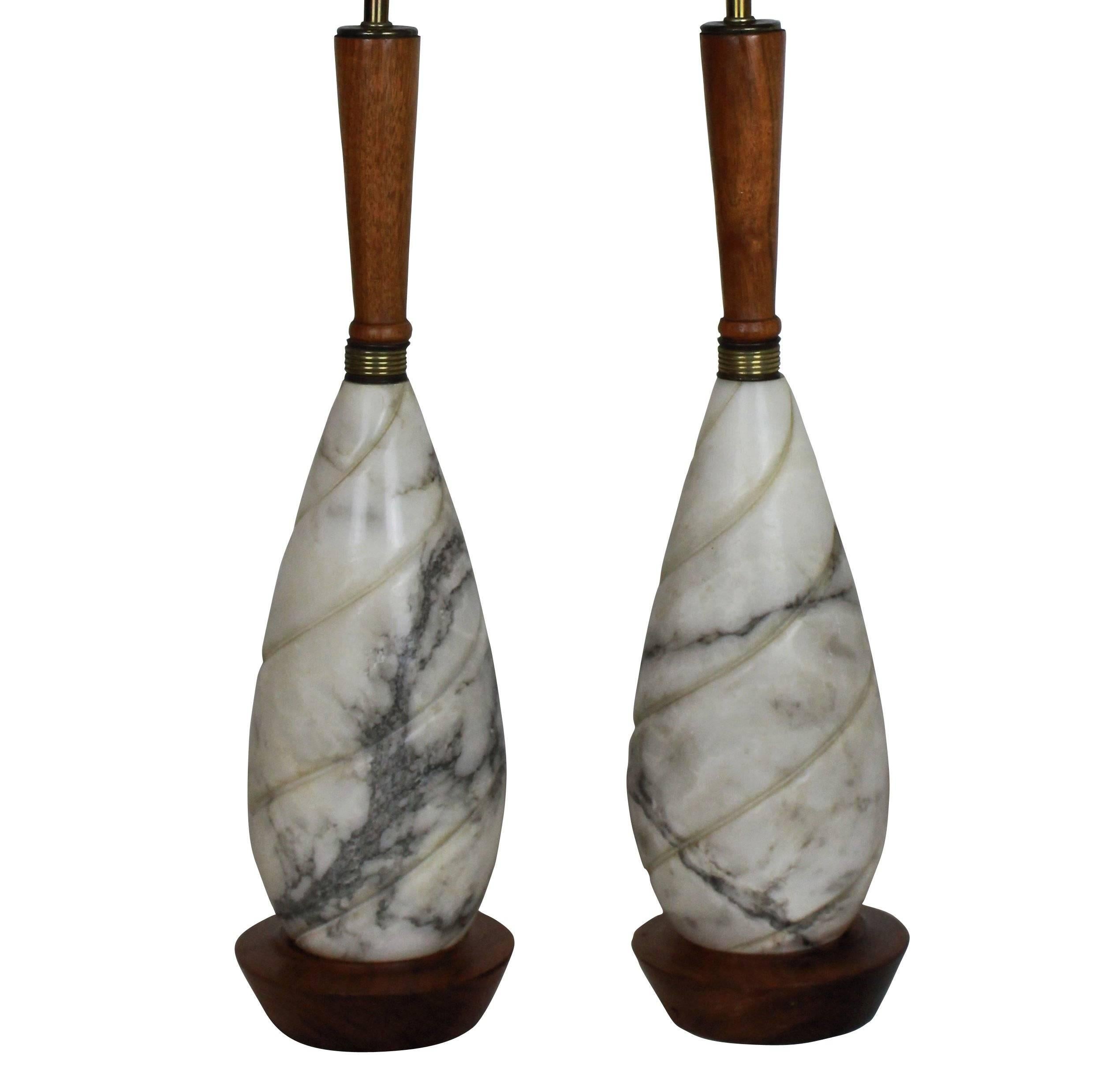 A pair of French marble and teak table lamps of elegant proportions.
   