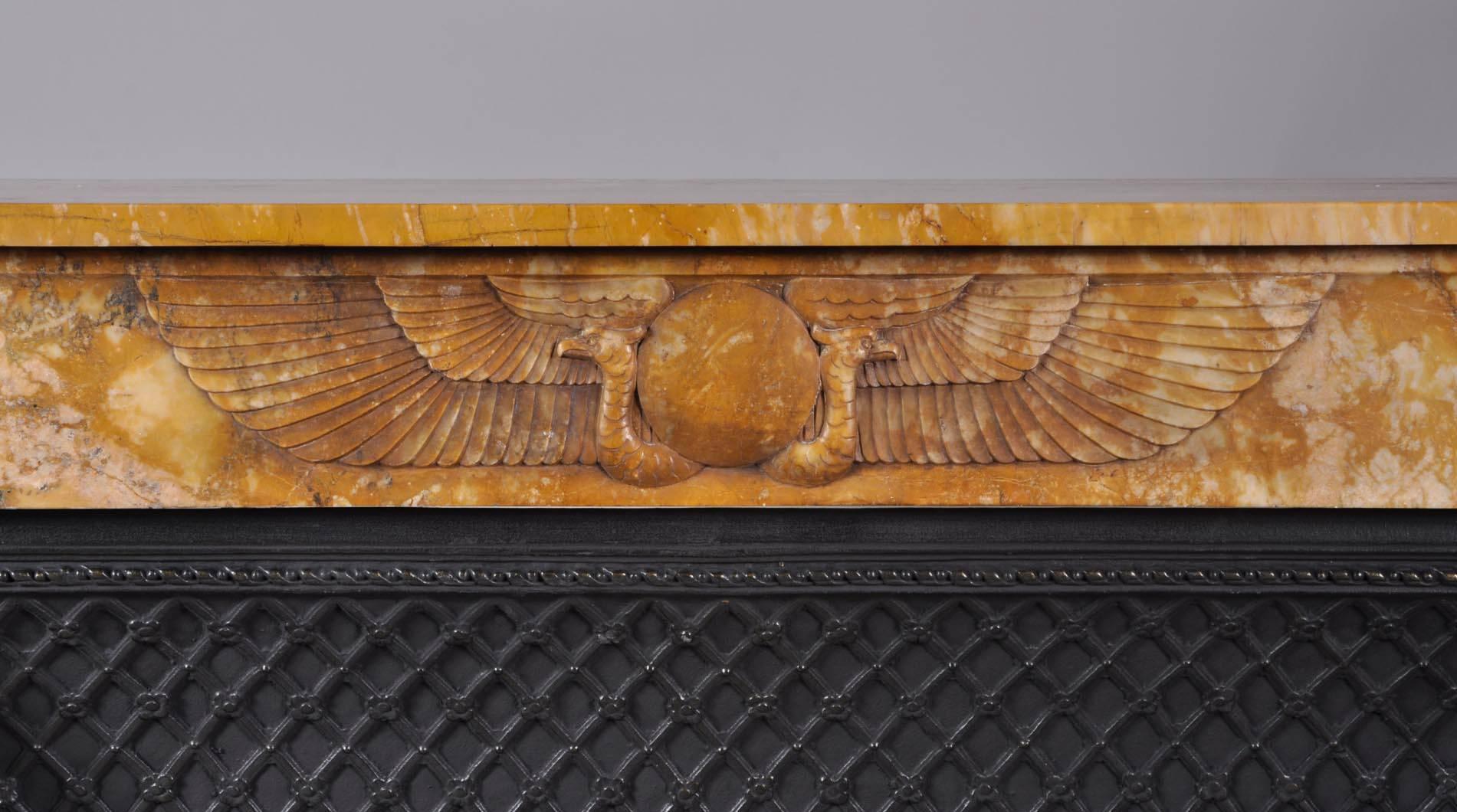 This rare fireplace is a beautiful example of the Egyptian revival style in the late 19th century, in France. This yellow marble is called 