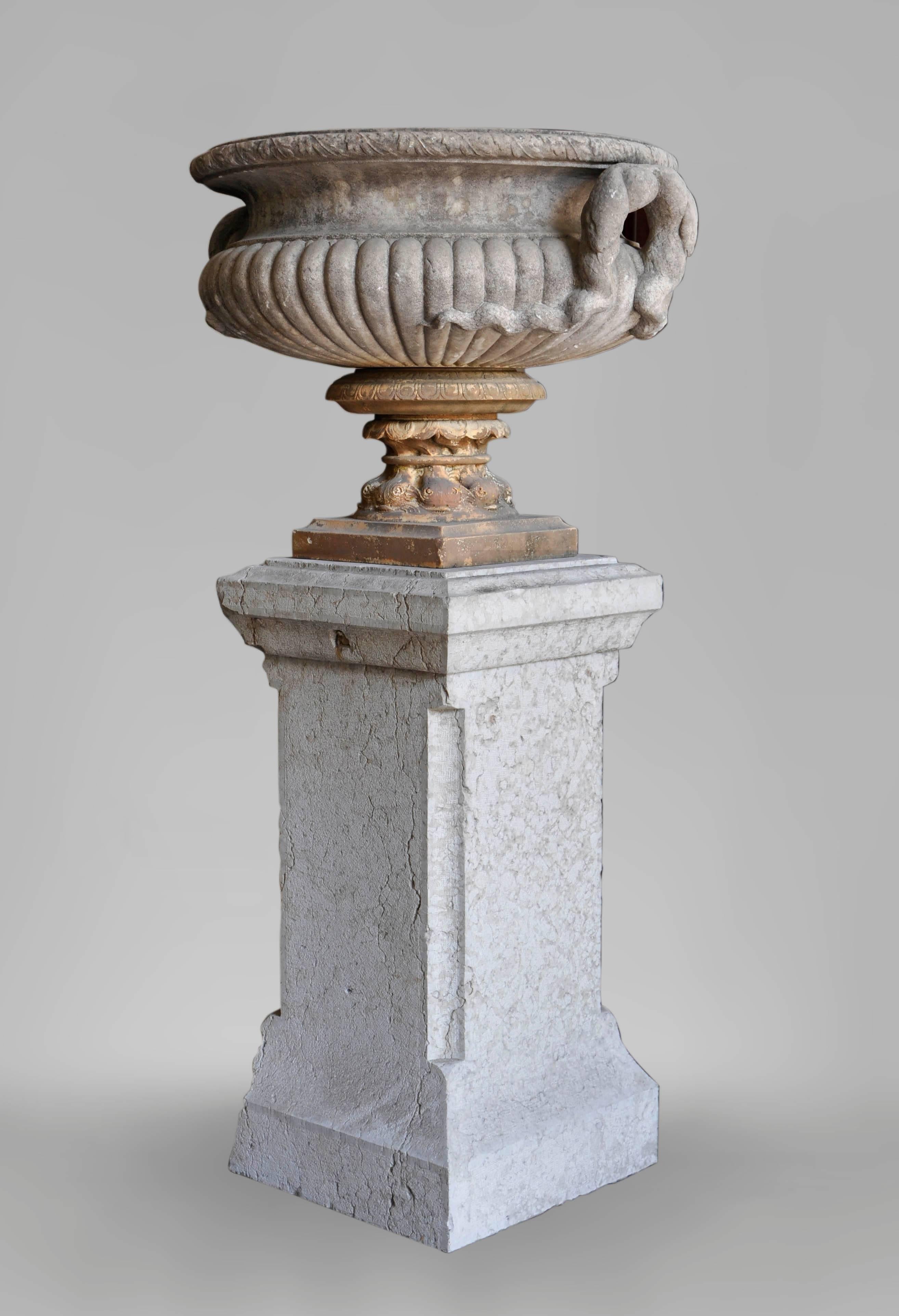 This set of four antique marble vases with terra-cotta pedestals was realized in the late 18th century or early 19th century in Italy. The vases' paunch are fluted whereas handles are figuring snakes in a high relief sculpture. The Medici style
