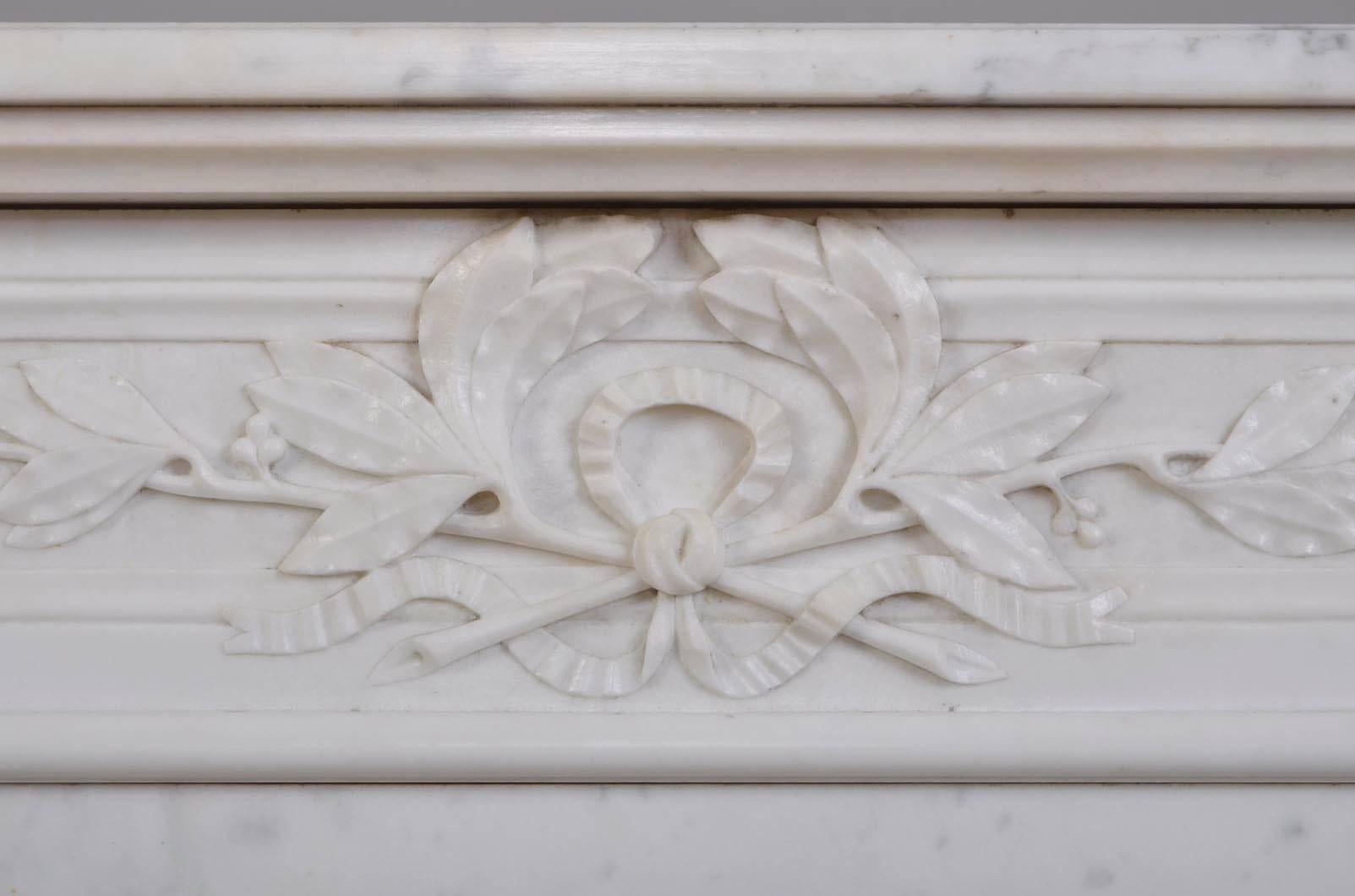 This antique Louis XVI style fireplace was made out of Carrara marble during the 19th century. The frieze is carved with intertwined laurel branches.
The fireplace is sold with a modern insert.