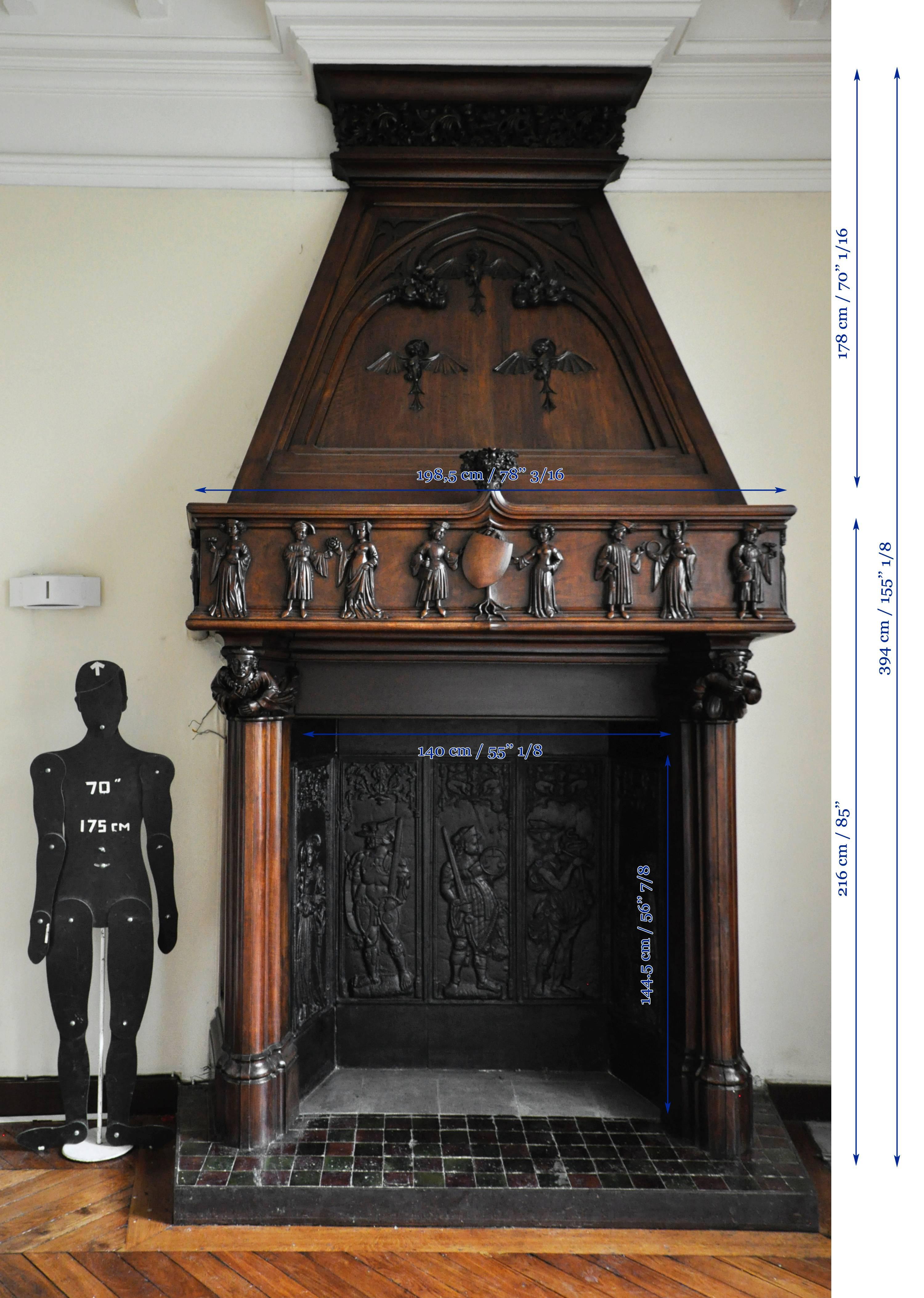 19th Century Neo-Gothic style carved walnut fireplace with hood, 19th c. For Sale