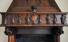 Neo-Gothic style carved walnut fireplace with hood, 19th c.