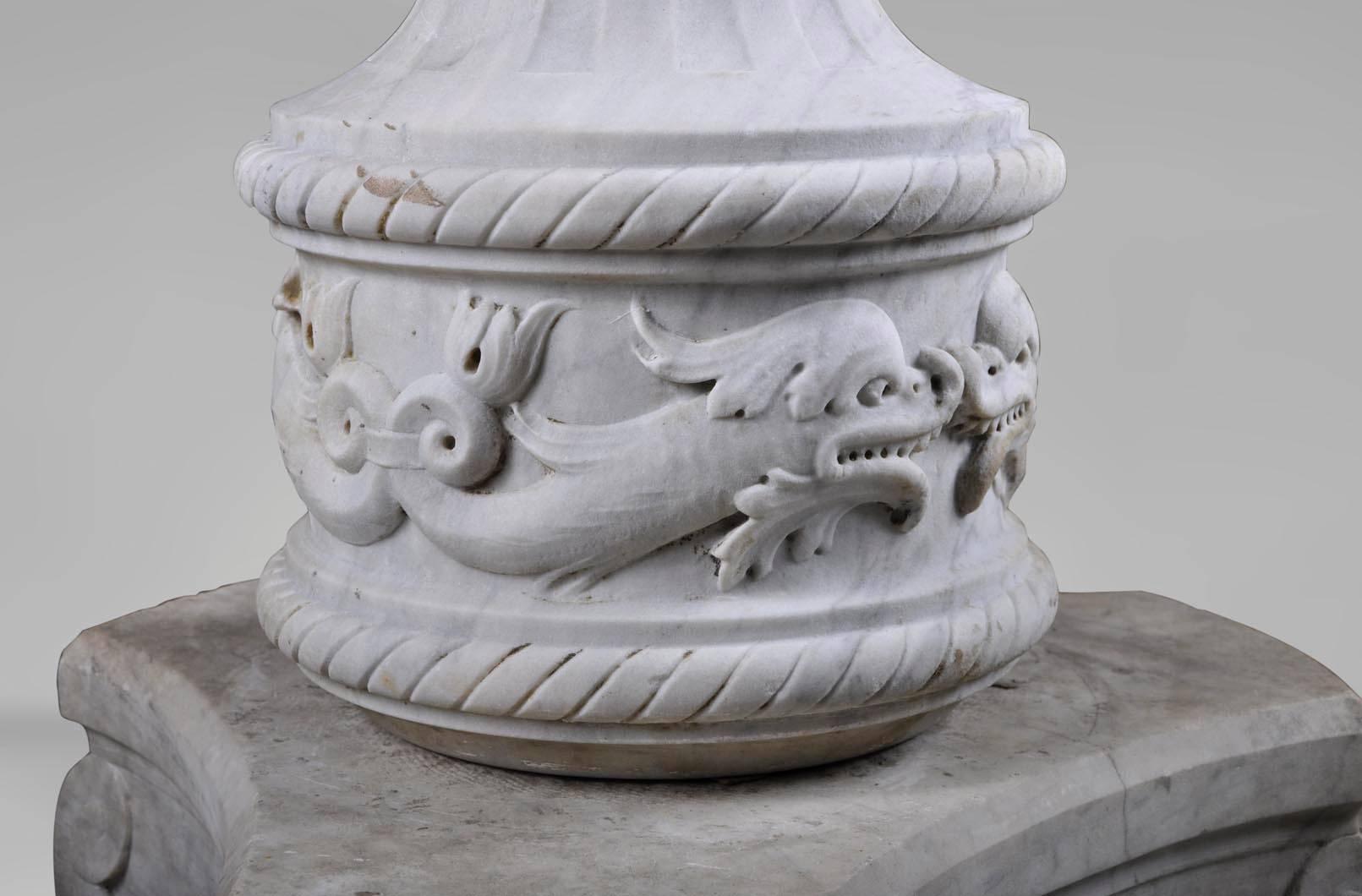 Beautiful Carrara marble fountain with a decor of dolphins and fruit garland. This Renaissance Revival piece is a very elegant ornament for a garden or a winter garden.