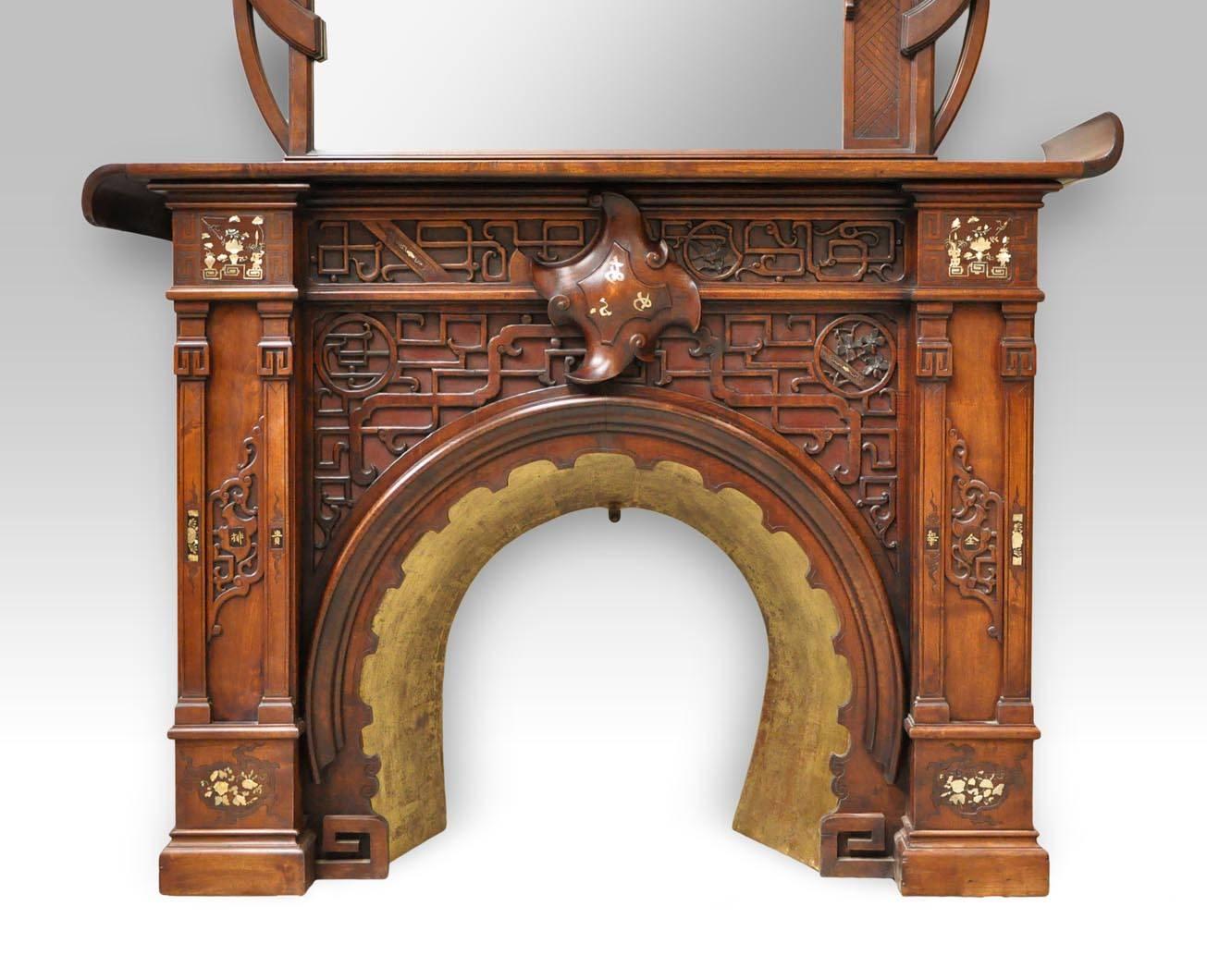 Antique Japanese style fireplace made out of carved walnut in the late 19th century. The realization of this beautiful fireplace is attributed to the Maison des Bambous by Perret and Vibert in Paris.
The decor consists of both engraving and