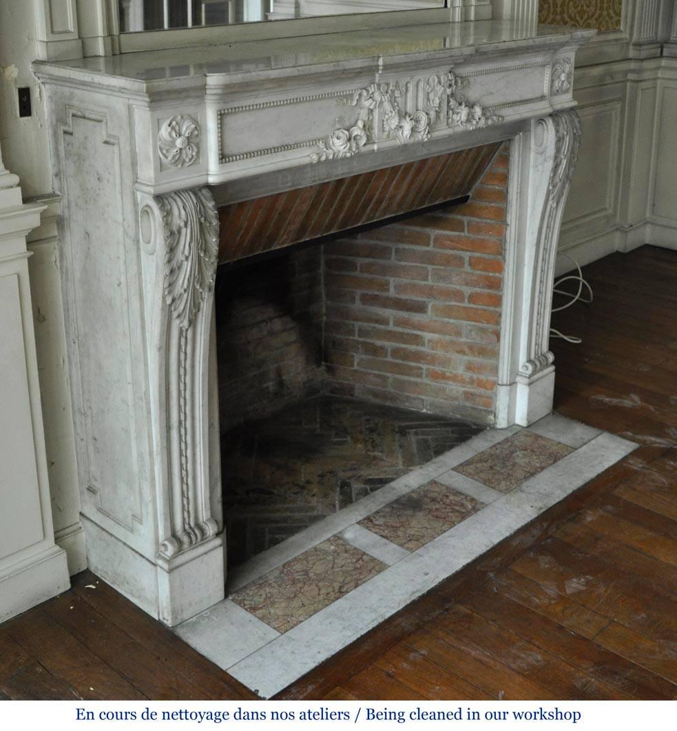 French Louis XVI Style Fireplace in White Carrara Marble with Carved Garland of Flowers