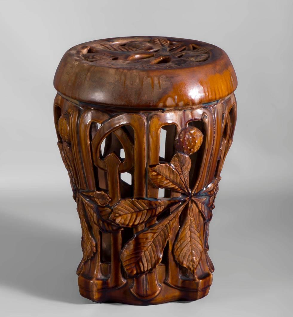 Rare antique ceramic stool decorated with leaves of chestnut trees and their bugs of Art Nouveau style realized, circa 1900.