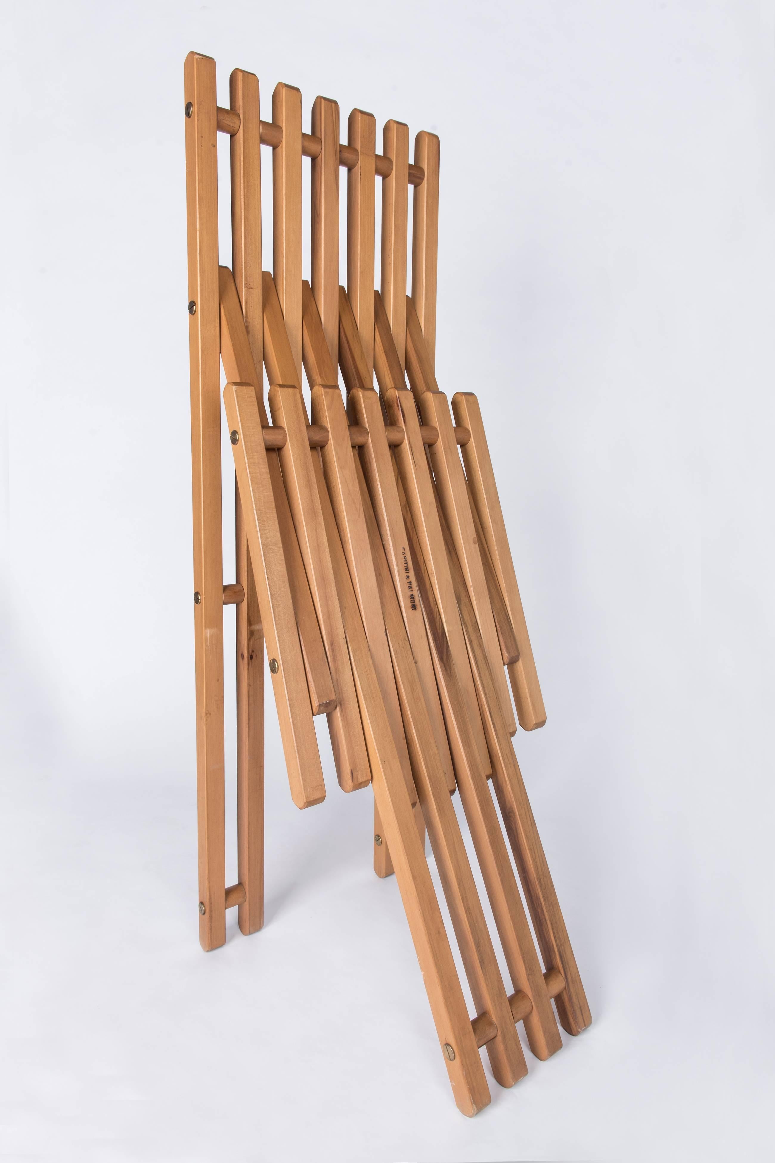 A pair of teakwood folding chairs edited by Capitini & Palmoni, stamped underneath. These chairs are the perfect examples how to combine comfort and design. They can be used as dining chairs as well as side chairs. They are in perfect authentic