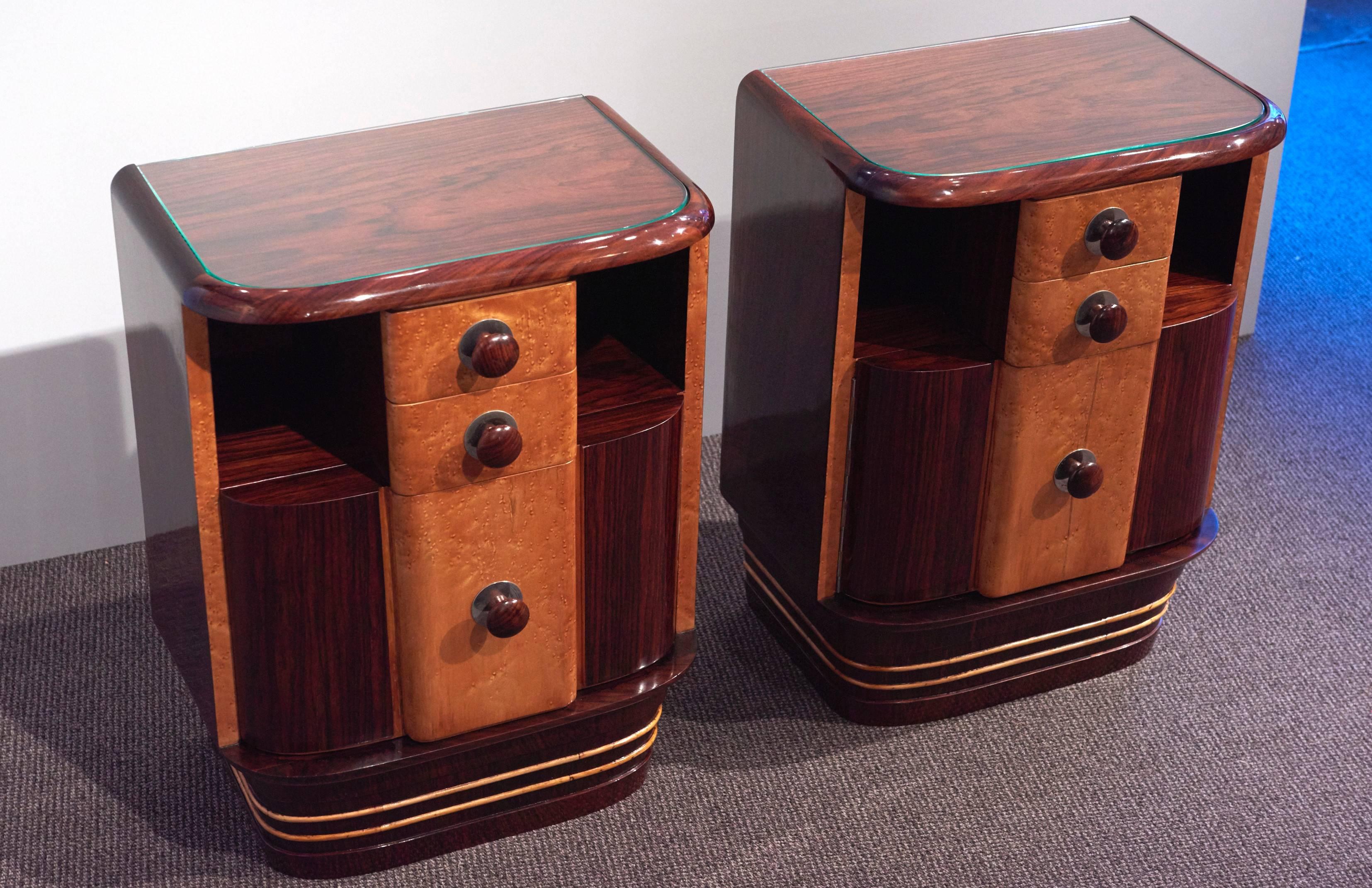 Italian origin pair of art-deco night stands.Dark rosewood and maple veneer,finished with a hand made lustrous french polish, original bakelit hardwares.They were restored recently,The cubist forms and the elegance of these pieces give the