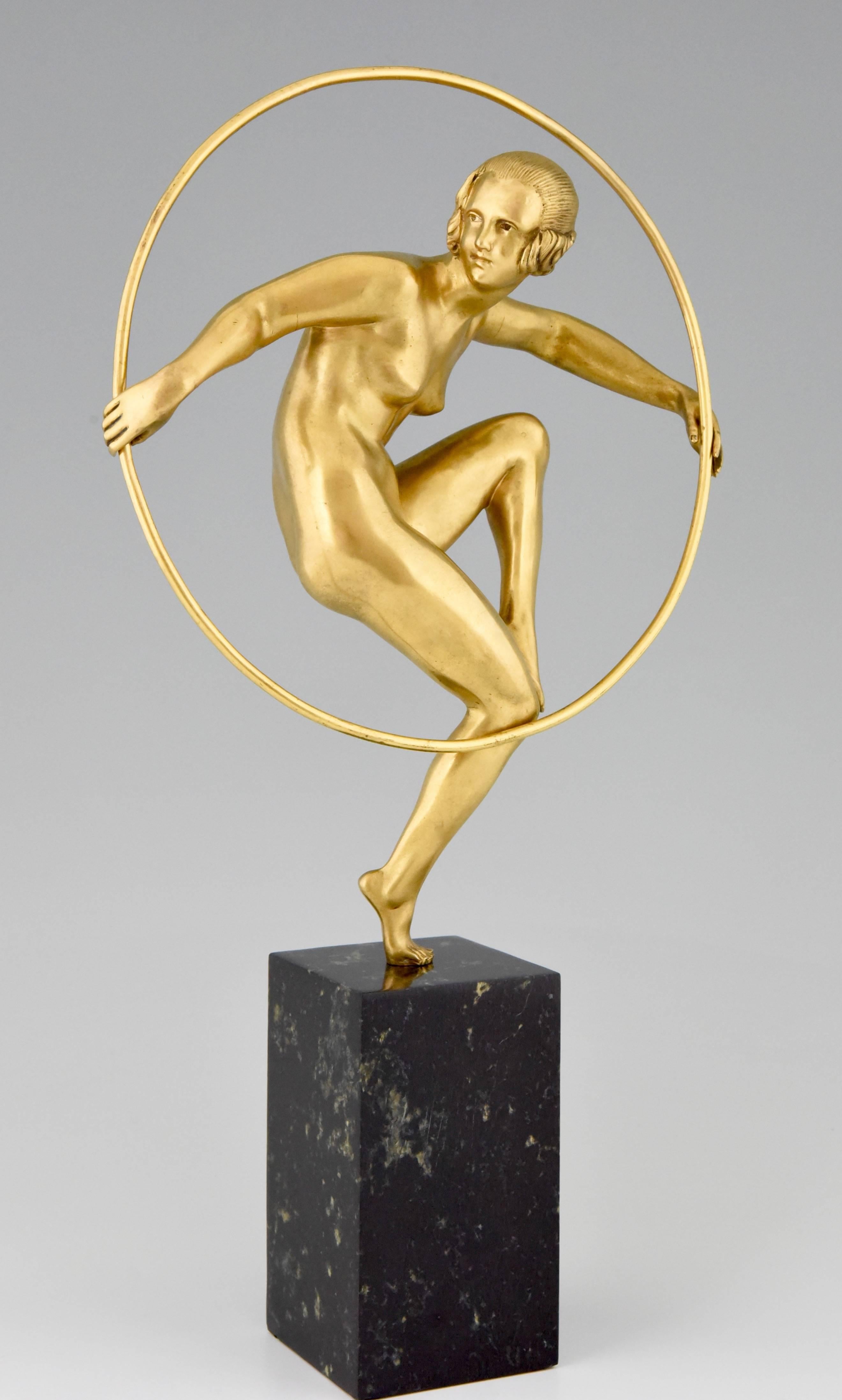 Description: 
Girl with hoop.
Nude dancing on one leg holding a hoop.

Artist/ Maker:
Marcel André Bouraine, 1886-1948. 

Signature/ Marks : 
A. Bouraine.

Style:
Art Deco.

Date:
circa 1930.

Material: 
Gilt bronze on a marble base. 

Origin: