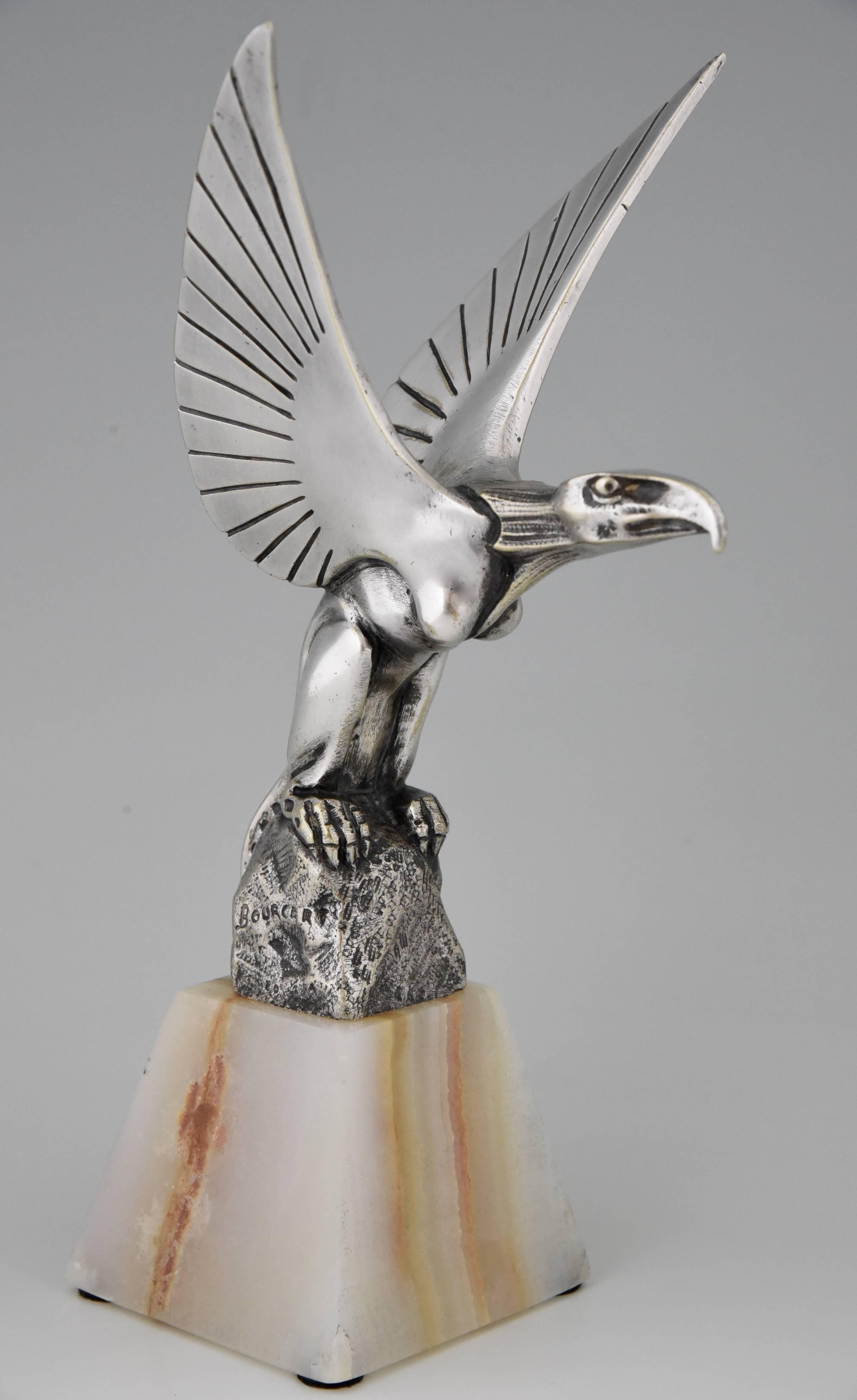 Art Deco silvered bronze car mascot or hood ornament of a Chimere on a rock; mythological winged animal with head of an eagle, by the French artist Gaston H. Bourcart.

Artist / maker:
G. H. Bourcart.
Signature / marks:
Bourcart.
Style:
Art