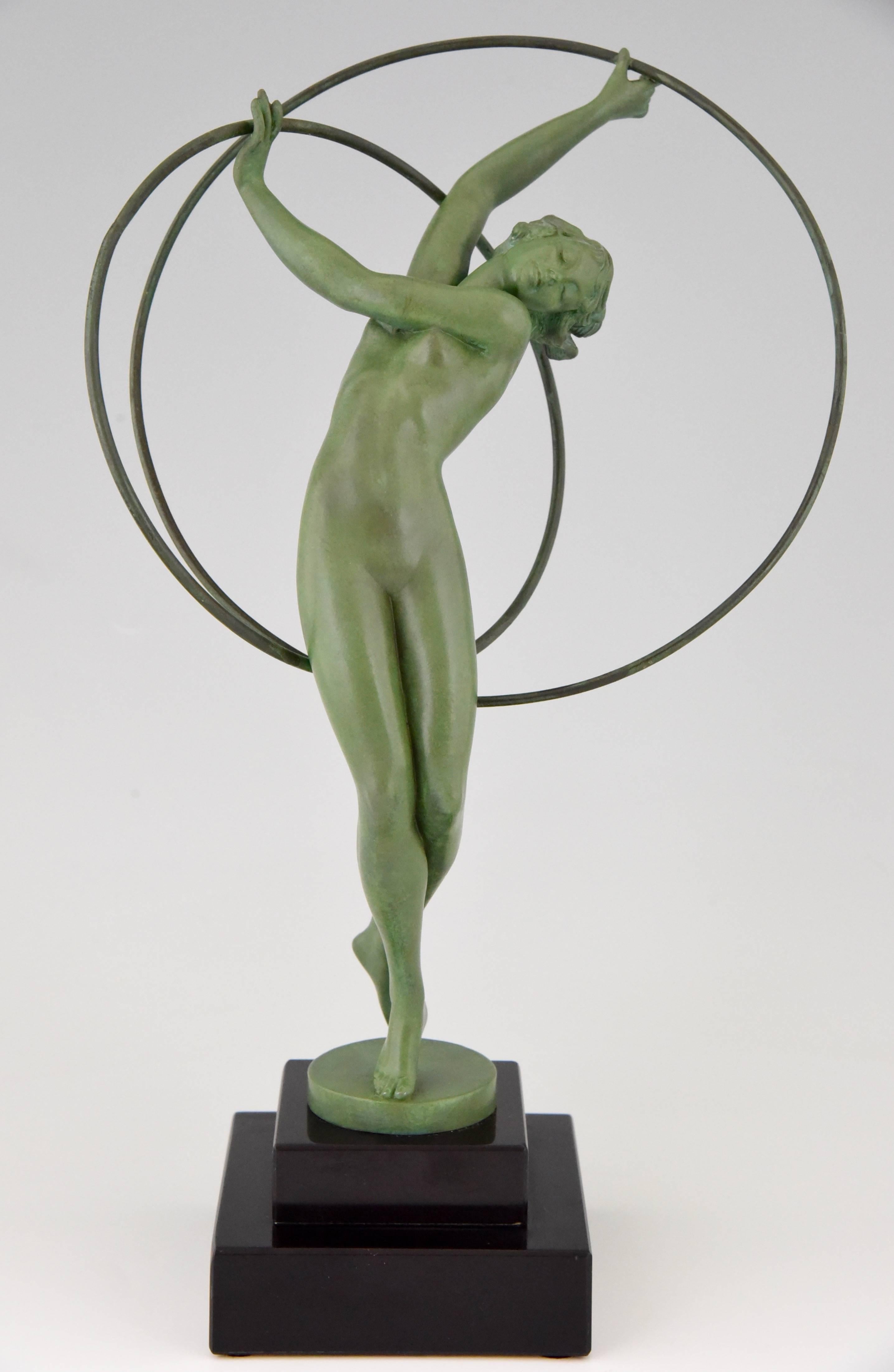 Elegant Art Deco nude hoop dancer signed Fayral, pseudonym of the french artist Pierre Le Faguays.

Artist / Maker:
Fayral, Le Faguays.
Signature / Marks:
Fayral.
Style:
Art Deco.
Date:
1930
Material:
Metal with green patina.  Black