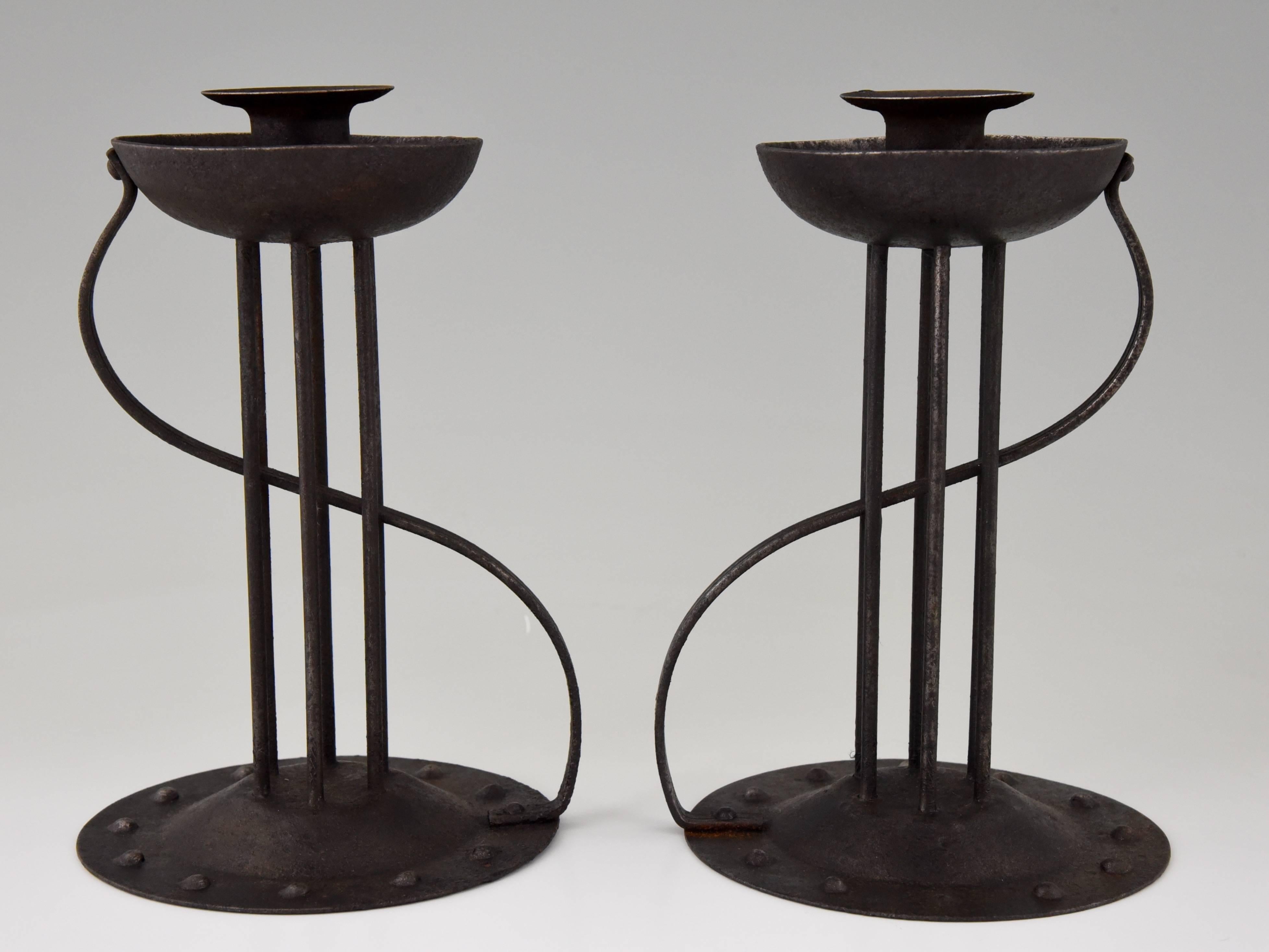 A pair of Art Nouveau wrought and hammered iron candlesticks by Goberg for Hugo bergere.

Artist / maker:
Goberg Hugo bergere. 
Signature / Marks:
Stamped Goberg.
Style:
Art Nouveau. 
Date:
1905-1910.
Material:
Hammered wrought