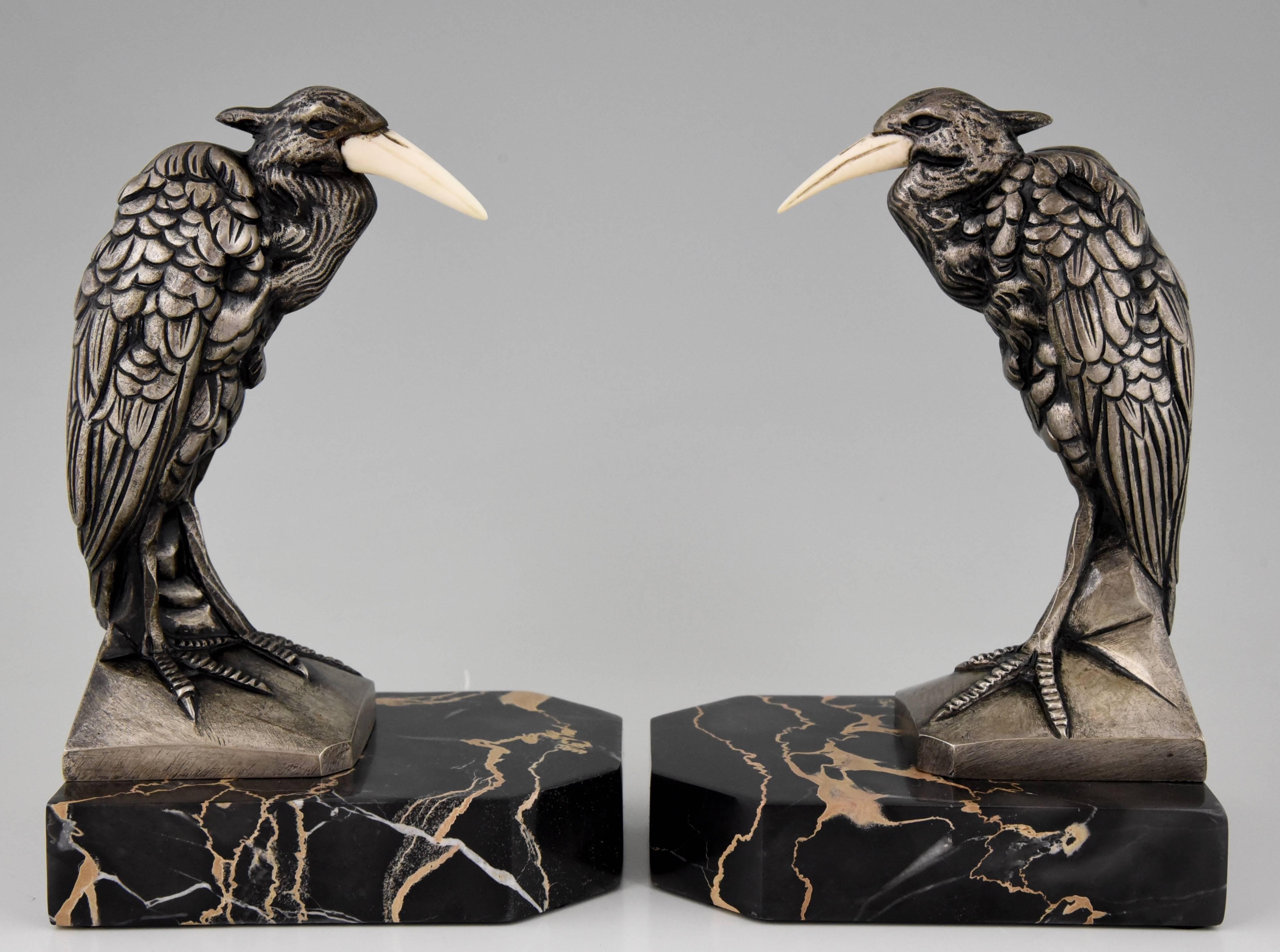 Description:  Art Deco bronze heron bird bookends on a marble base.
Artist / maker: Manin.
Signature / marks: Manin.
Style: Art Deco.
Date: 1930.
Material:  Bronze with silver patina.  Marble base.
Origin: France.
Size of one:
H. 7.7 inch. x
