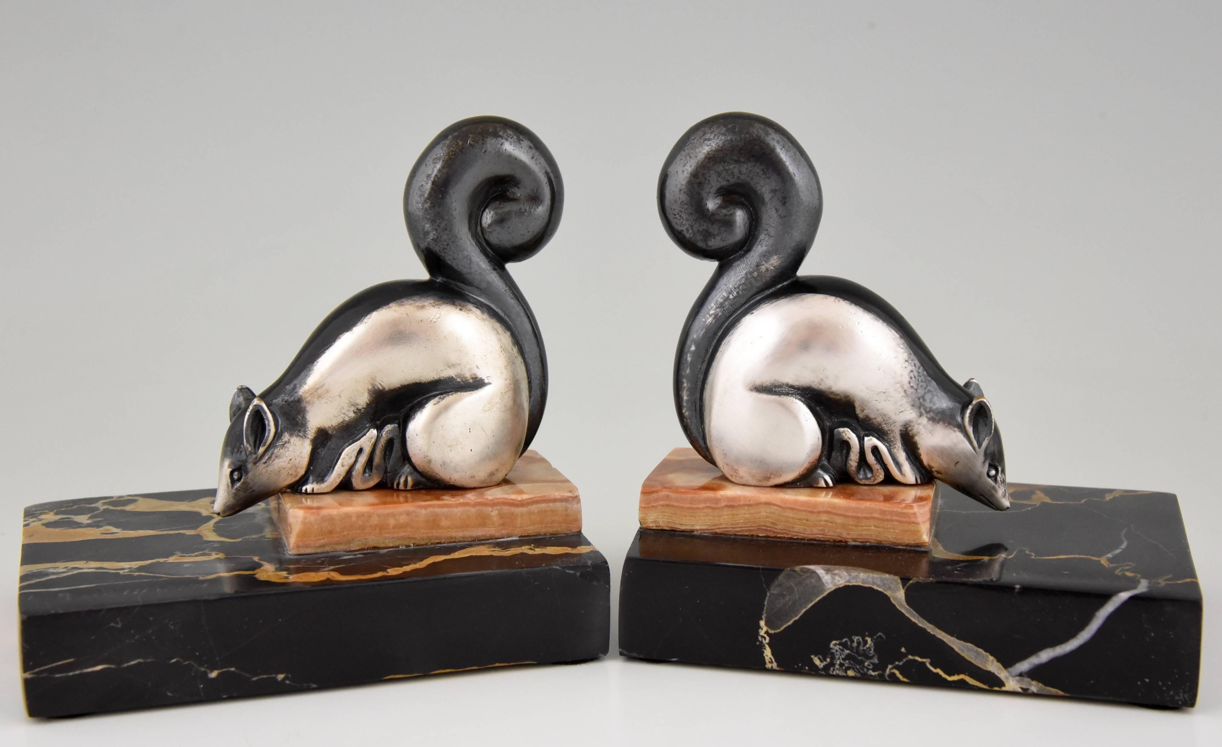 Very cute pair of Art Deco bronze squirrel bookends with a silver patina on a two color marble base.

Artist / maker:
Rischmann.
Signature / marks:
Rischmann.  Marked “bronze”.
Style:
Art Deco.
Date:
circa 1930.
Material:
Bronze with