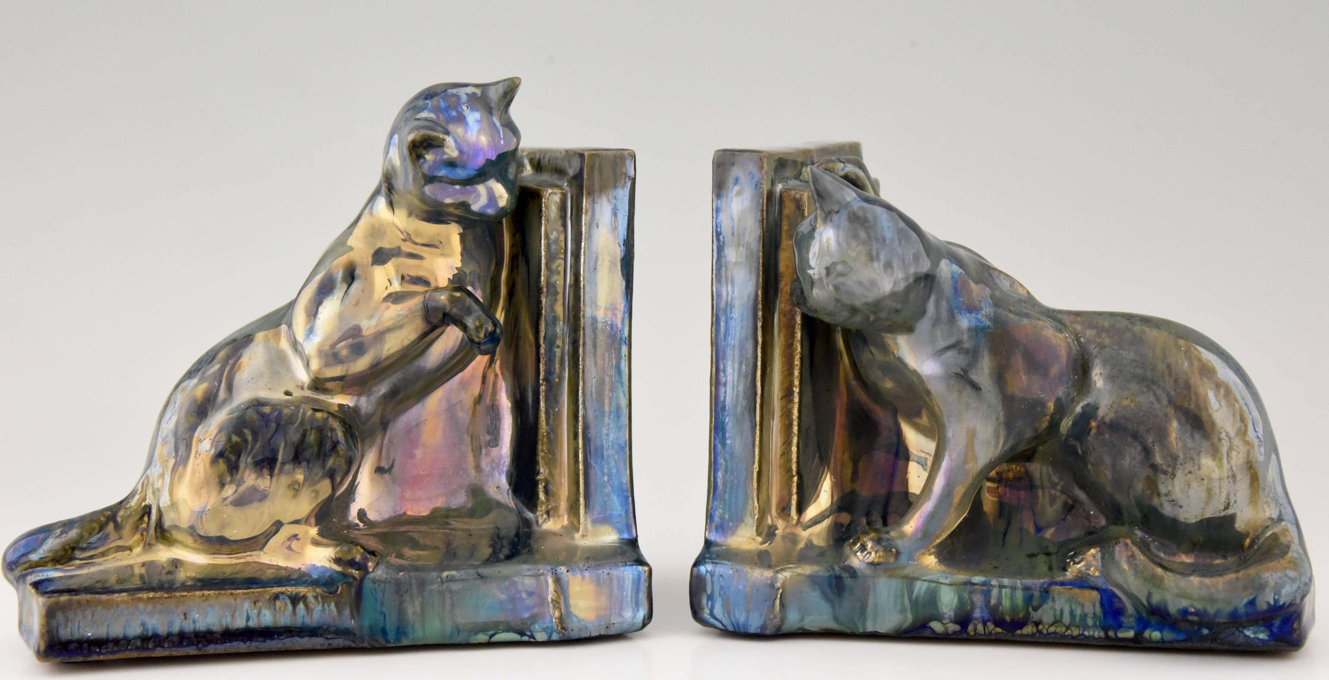 Lovely pair of ceramic cat bookends with iridescent glaze by A. Cytère for Rambervillers , Unis France  marked A. Schneider .

Artist / Maker:
A. Cytère Rambervillers.
Signature / Marks:
A. Cytère Rambervillers , Unis France , A.