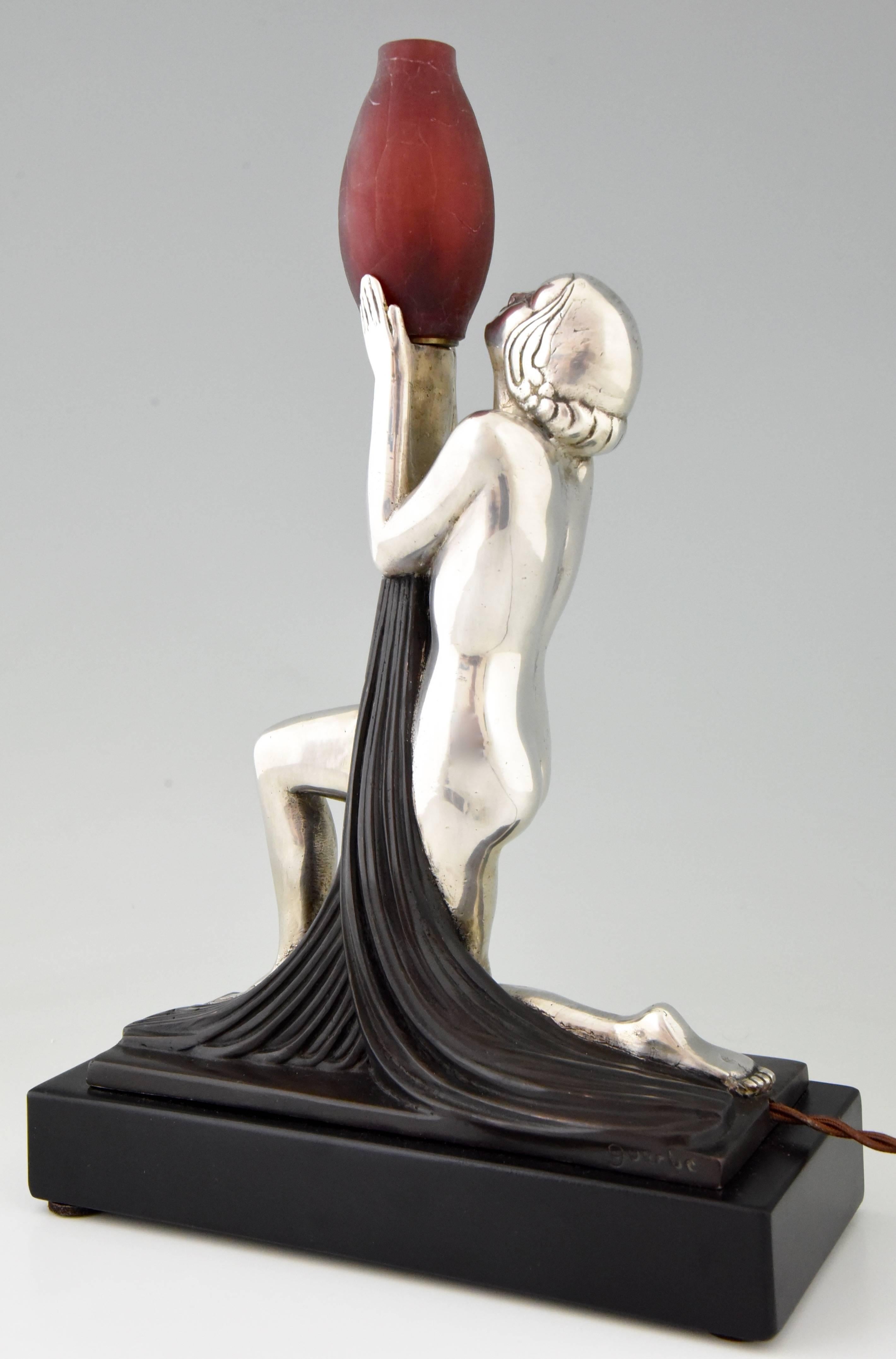 Elegant Art Deco silvered bronze lamp modeled as a kneeling nude holding a vase by Raymonde Guerbe, the wife of Pierre Le Faguays.

Artist/maker:
Raymonde Guerbe.
Signature/marks:
Guerbe.
Style:
Art Deco.
Date:
1930.
Material:
Silvered