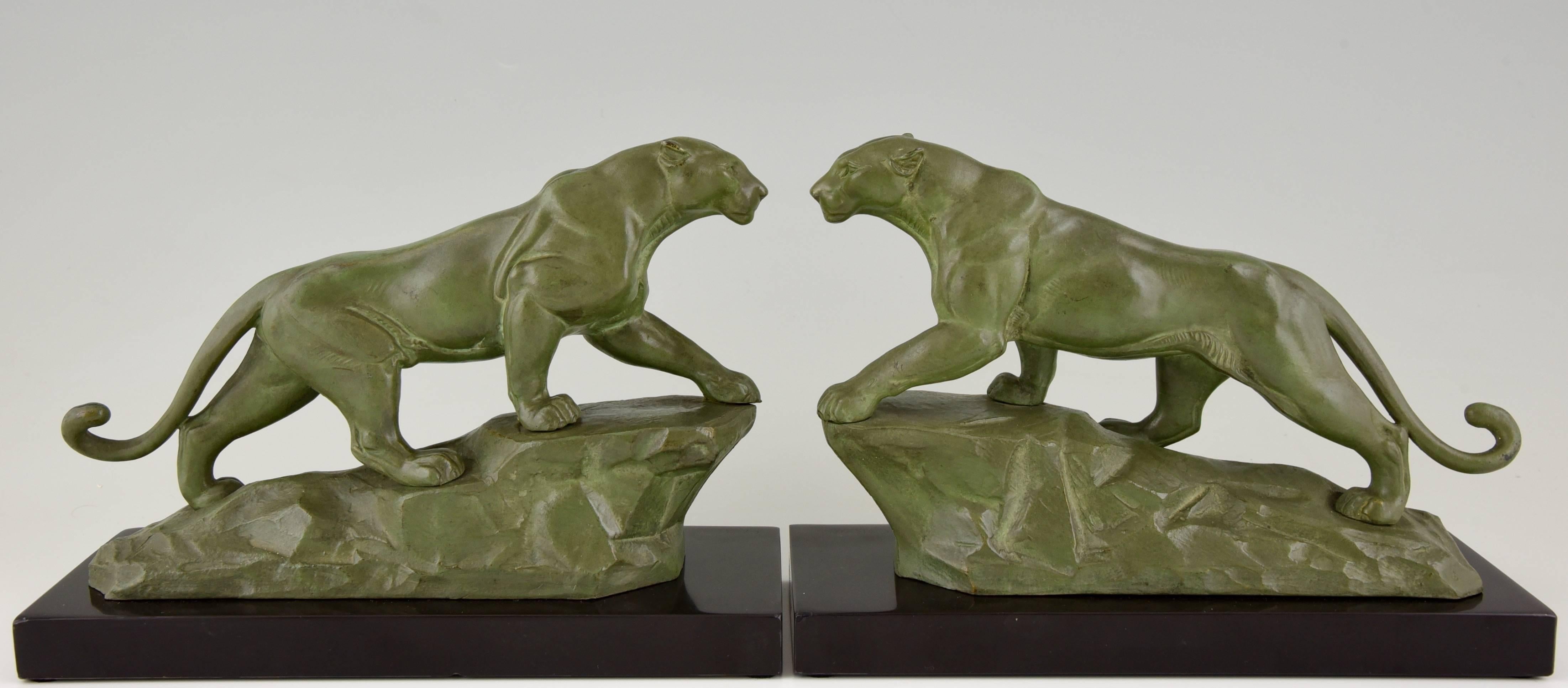 A very nice pair of Art Deco panther bookends by the French artist Louis Albert Carvin on a marble base. 

Artist / Maker:
Louis Albert Carvin.
Signature / Marks:
Carvin.
Style:
Art Deco.
Date:
1930.
Material:
Patinated metal on a marble