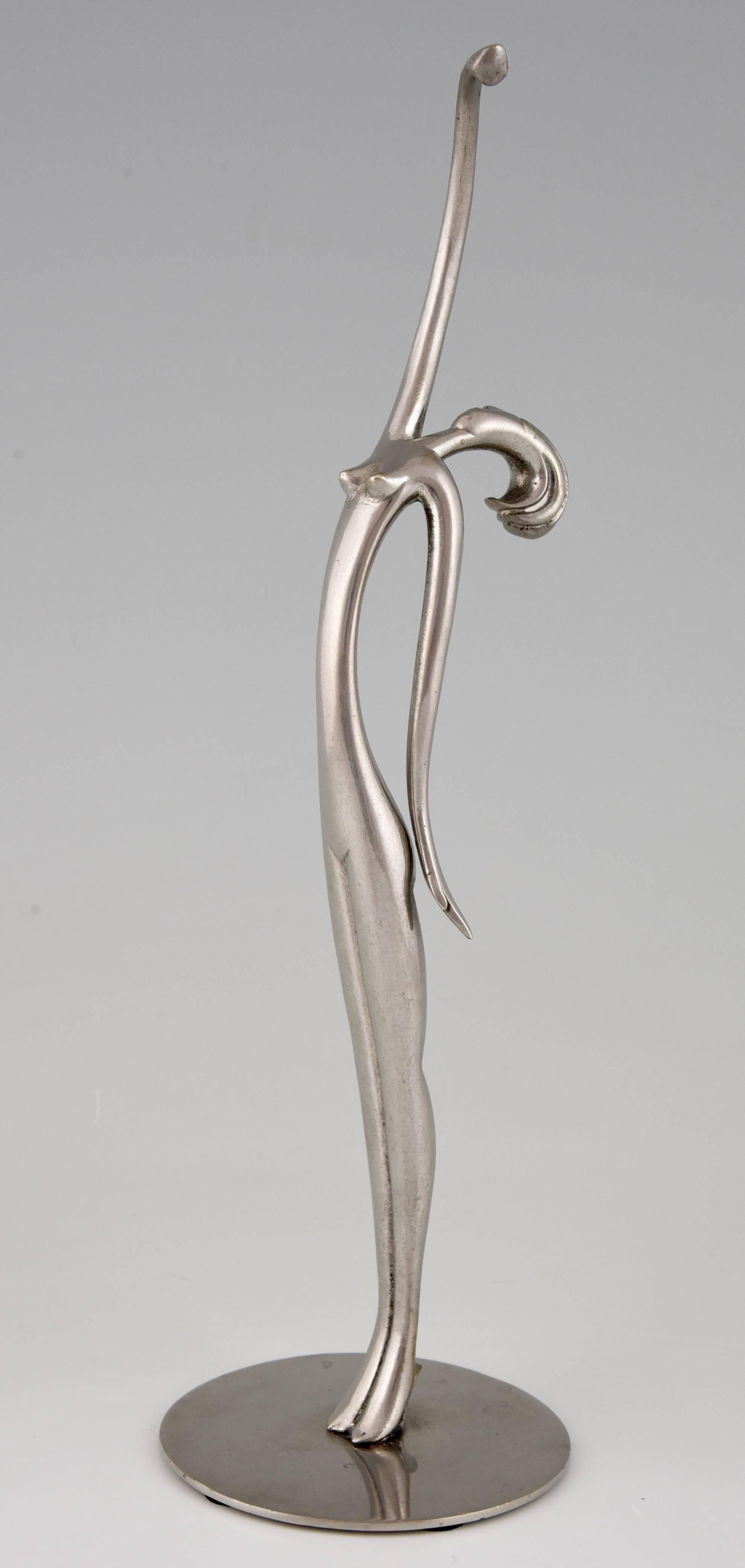 An elegant Art Deco modernist figure of a standing female nude. Attributed to Karl Hagenauer 1898-1956 

Style:
Art Deco.
Date:
1930.
Material:
Nickel-plated bronze. 
Origin:
Austria.
Size cm:
H 30.5 cm. x L 9 cm. x W 9 cm. 
Size