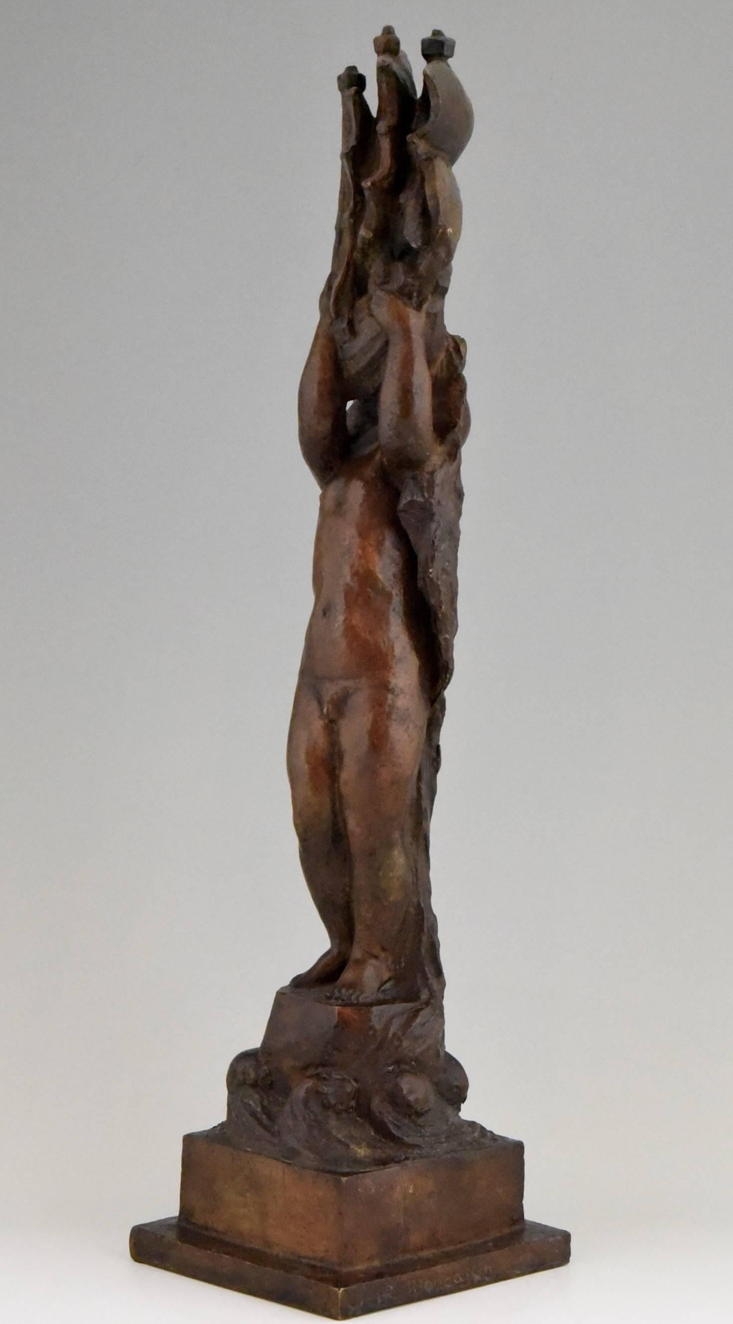 A typical Art Deco bronze modeled as a naked young boy wearing a hat, lifting a sailing boat high in the air. He is standing on a rock in the sea by the French artist Henri Raphael Moncassin, Foundry mark Susse Frère, lost wax technique. 

Artist/