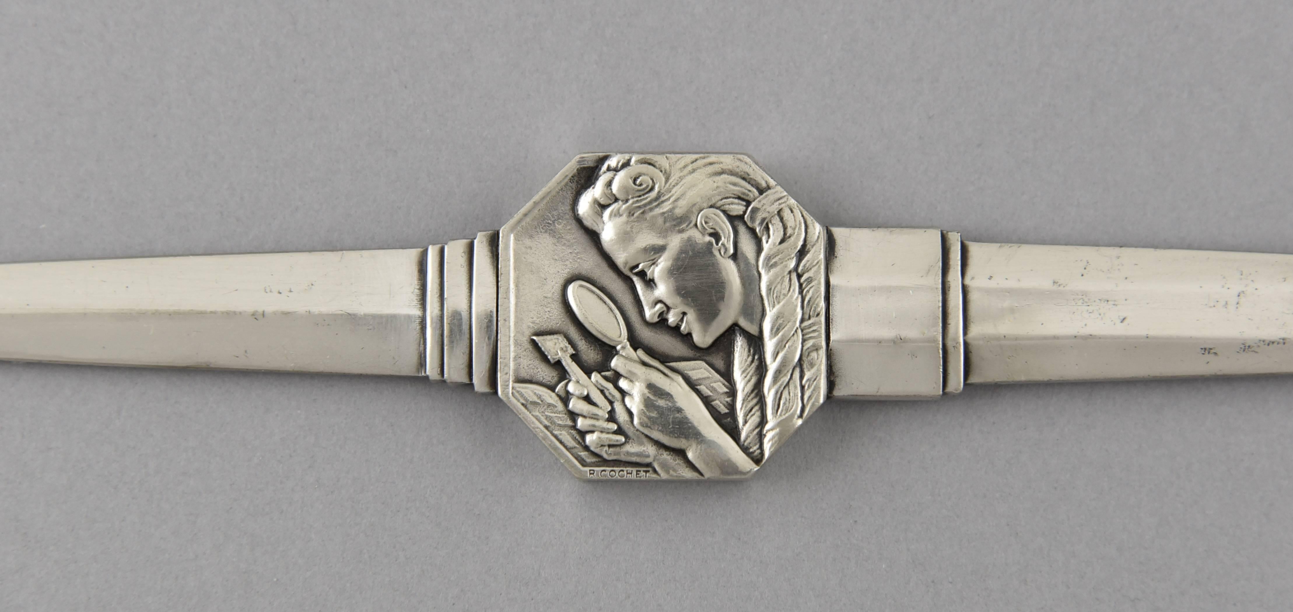 “Philateliste.”
Art Deco silvered bronze letter opener picturing a stamp collector by the French artist Robert Cochet.

Artist/Maker: Robert Cochet.
Signature/ Marks: R. Cochet.
Style: Art Deco.
Date: circa 1930.
Material: Silvered