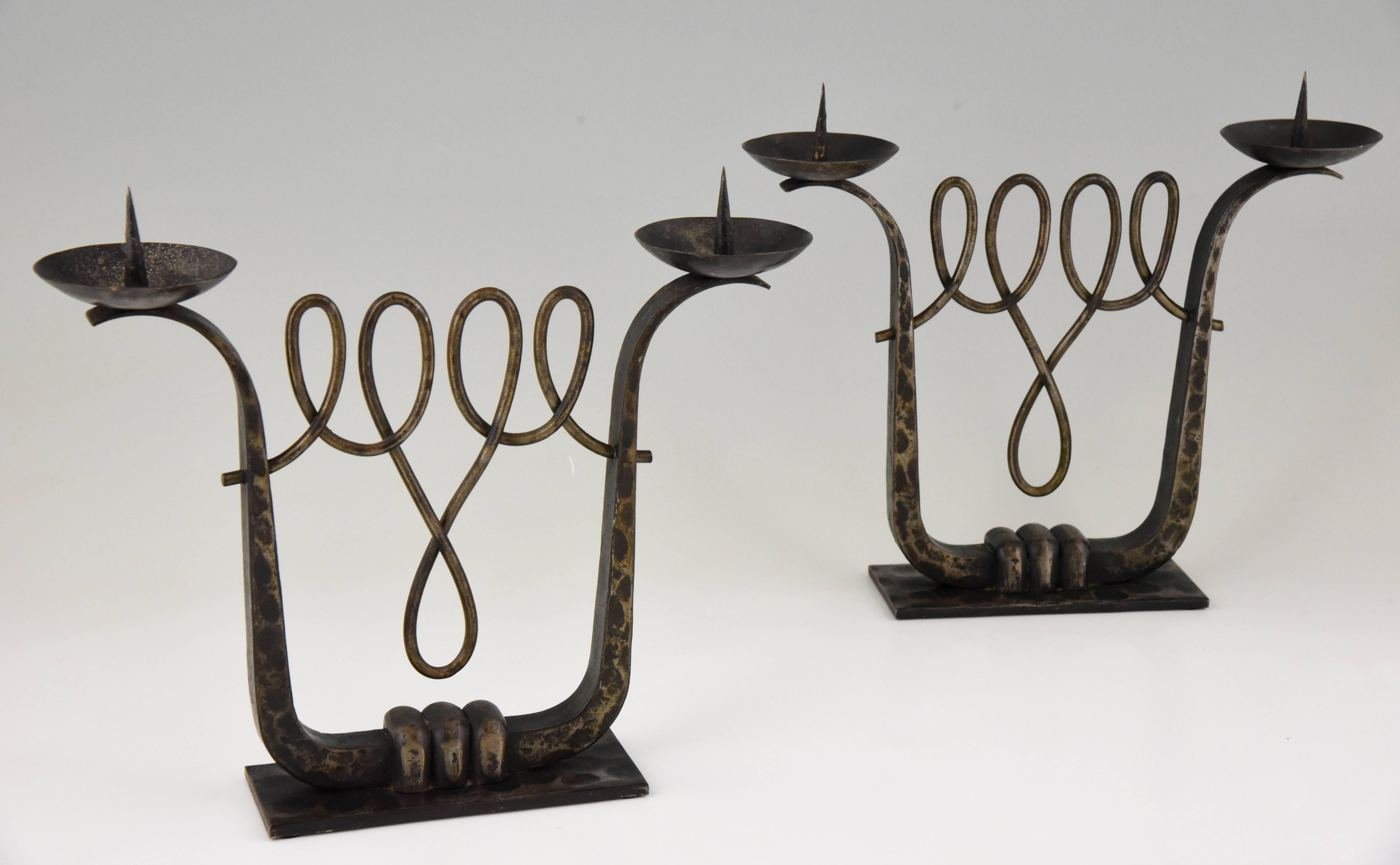 A fine pair of wrought iron two scone Art Deco candelabra by the French artist Michel Zadounaïsky.

Artist or maker: Michel Zadounaïsky.
Signature or marks: Zadounaïsky.
Style: Art Deco.
Date: 1925-1930.
Material: Patinated wrought
