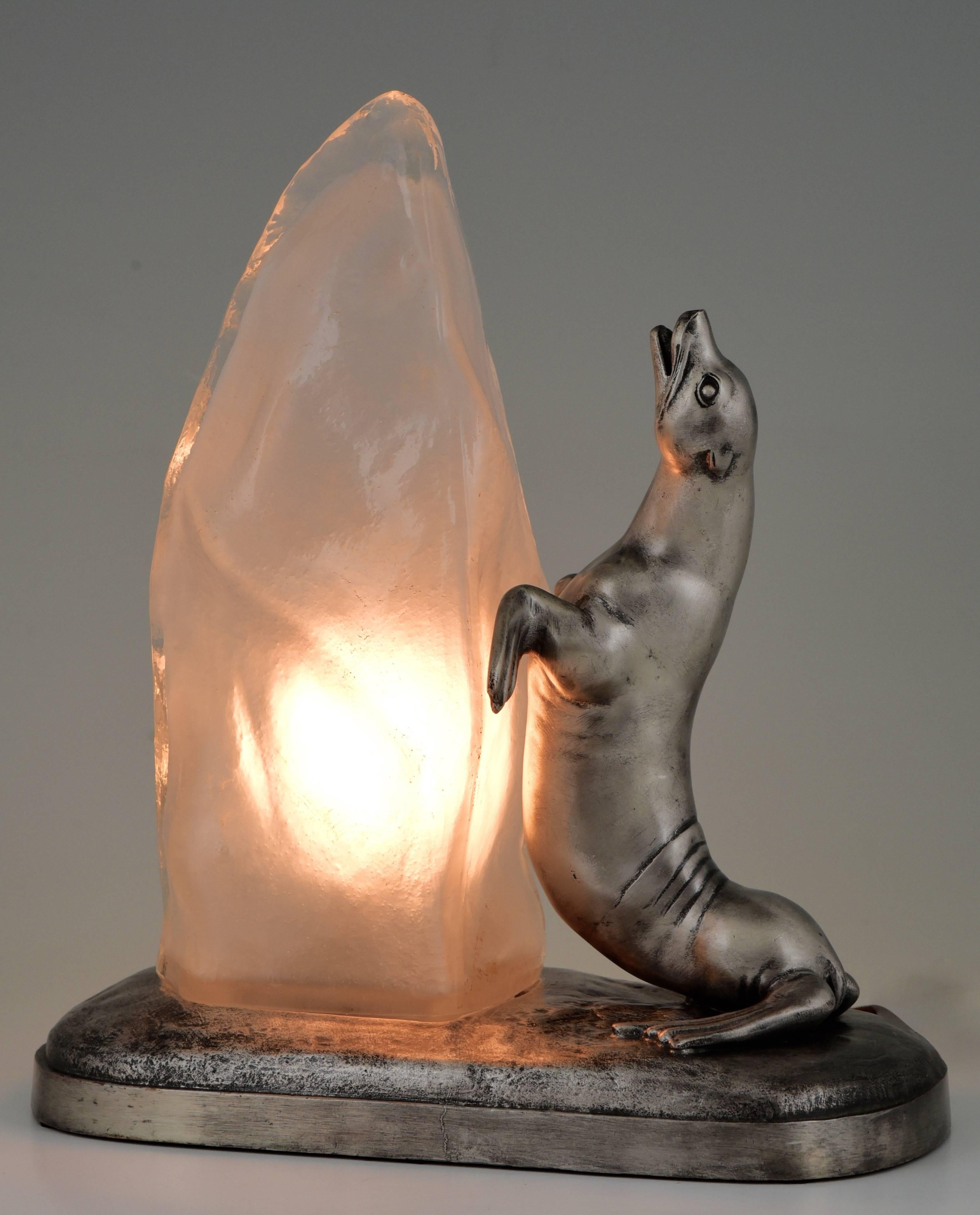 Adorable Art Deco lamp with a seal. The glass lampshade is modelled as a block of ice. Artist/ Maker: Louis Albert Carvin. Signature/ Marks: Foundry seal. Style: Art Deco. Date: 1930. Material: Art metal with silver patina and glass. Origin: France.