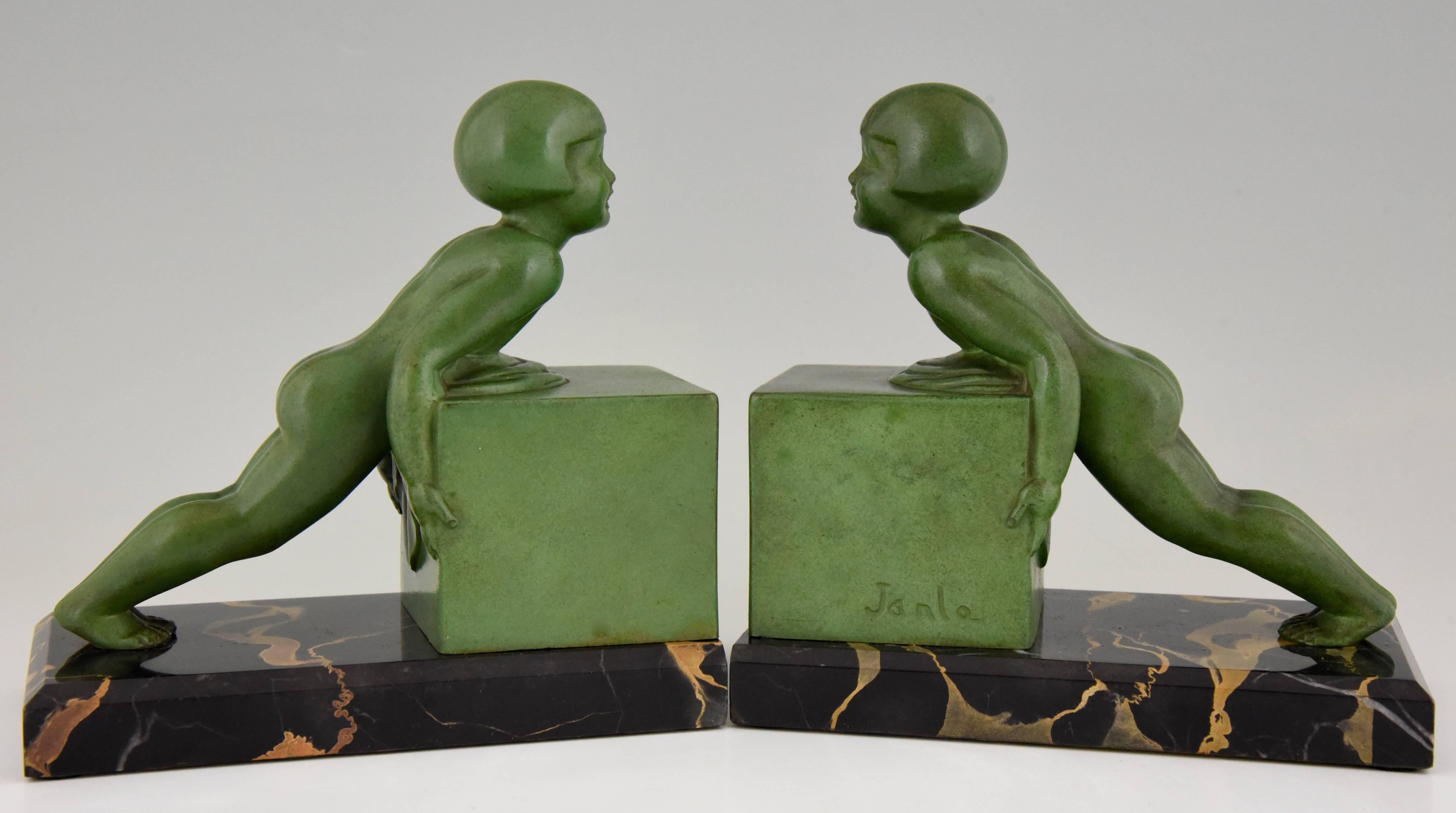 Signature/ Marks: Janle.
Style: Art Deco.
Date: 1930.
Material: Art metal with green patina. Portor marble base.
Origin: France.
Size: H 16.5 cm. x L 16.5 cm. x W 9 cm.  
H 6.5 inch x L 6.5 inch x W 3.5 inch
Condition: Excellent