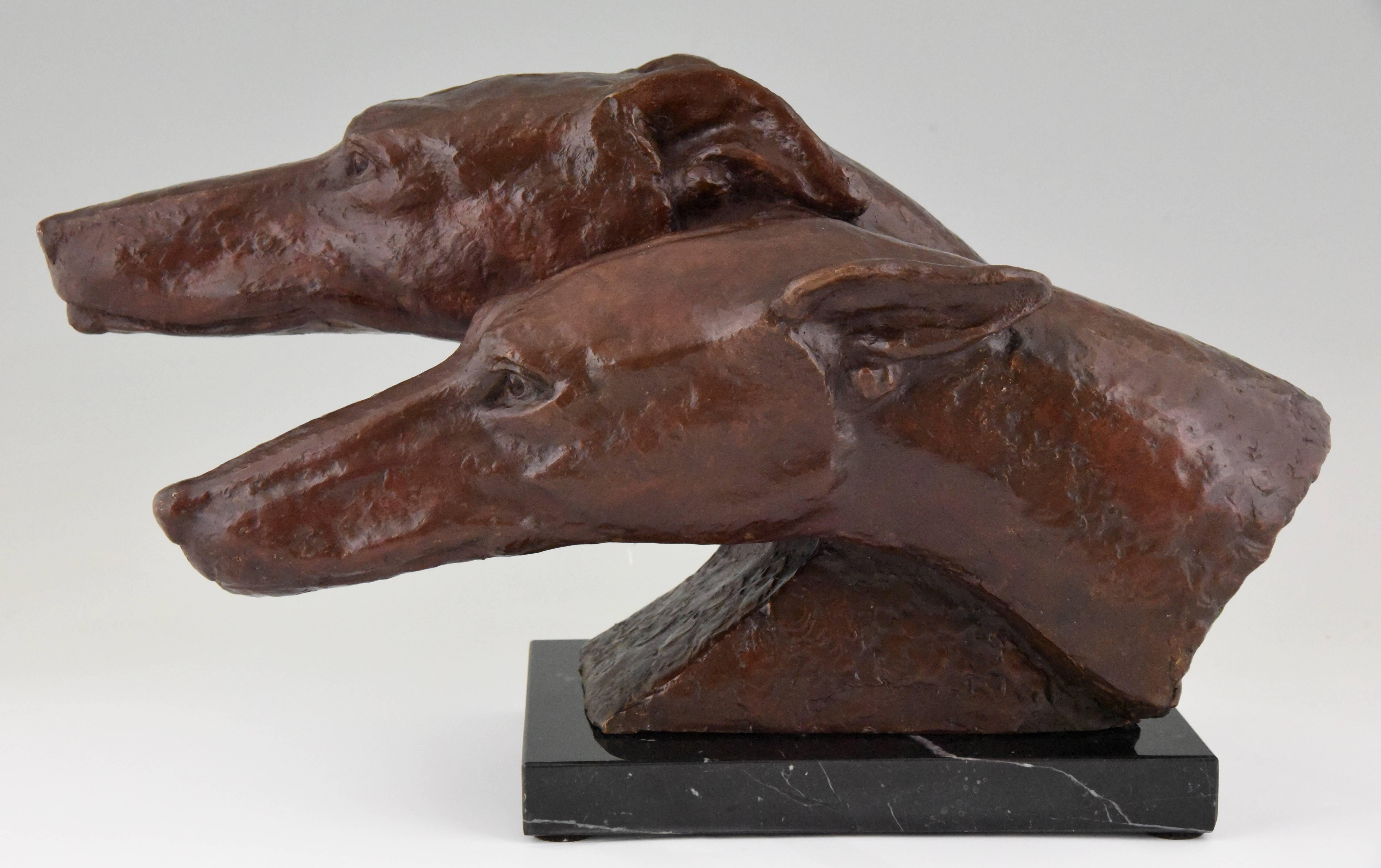 Very nice sculpture of a pair of bronze whippet dogs or Greyhounds. 

Signature/ marks: Indistinct signature.
Style: Art Deco.
Date: 1930.
Material: Patinated bronze. Marble base.
Origin: France
Size: H. 28 cm x L. 50 cm. x W. 25 cm.
H. 11