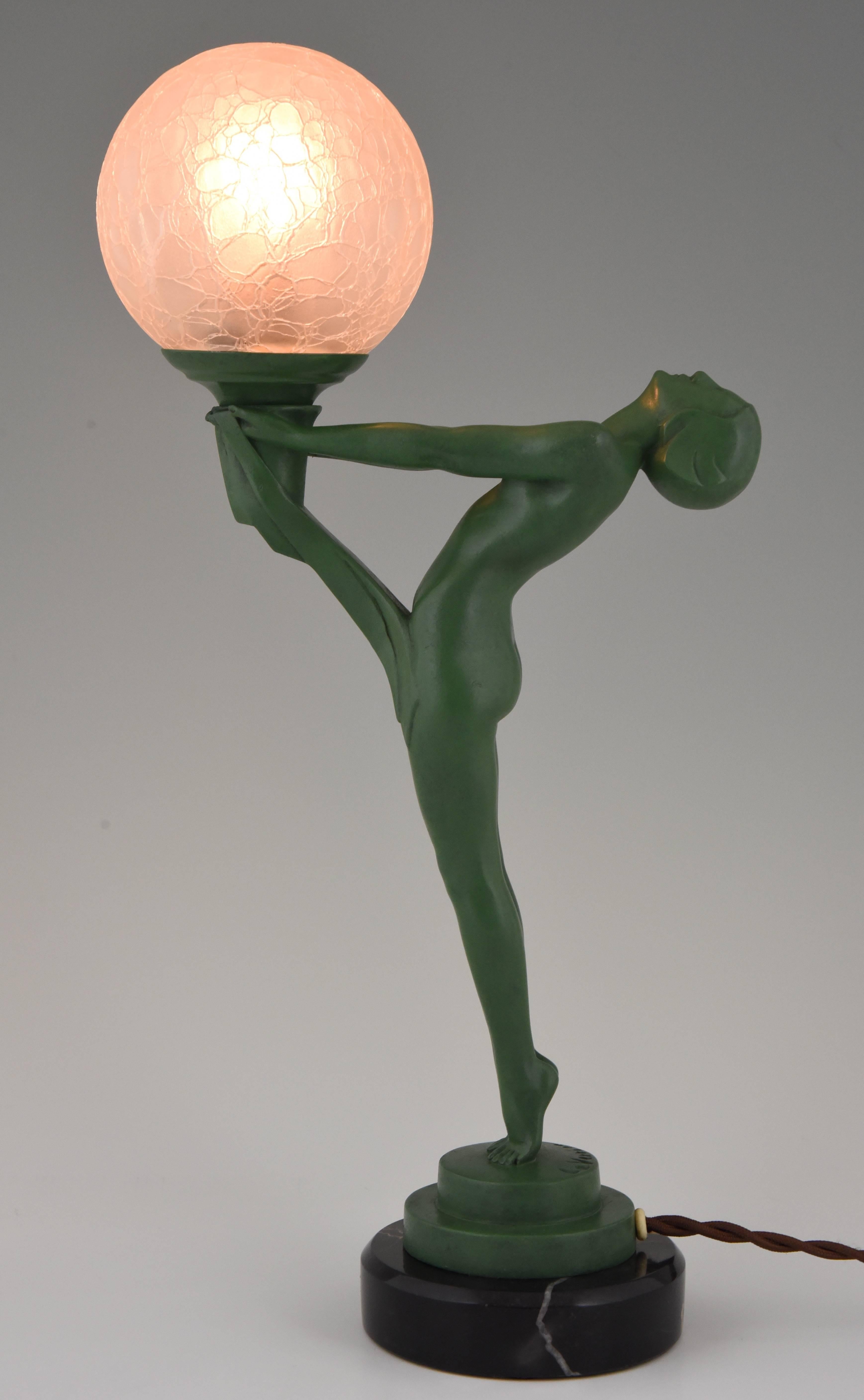 Art Deco figural table lamp with standing nude.
Max Le Verrier

Signature/ Marks: Le Verrier
Style: Art Deco
Date: 1930
Material: Green patinated metal. Marble base. Crackled glass shade.
Origin: France
Size: H. 40 cm. x L. 19.5 cm. x W. 10