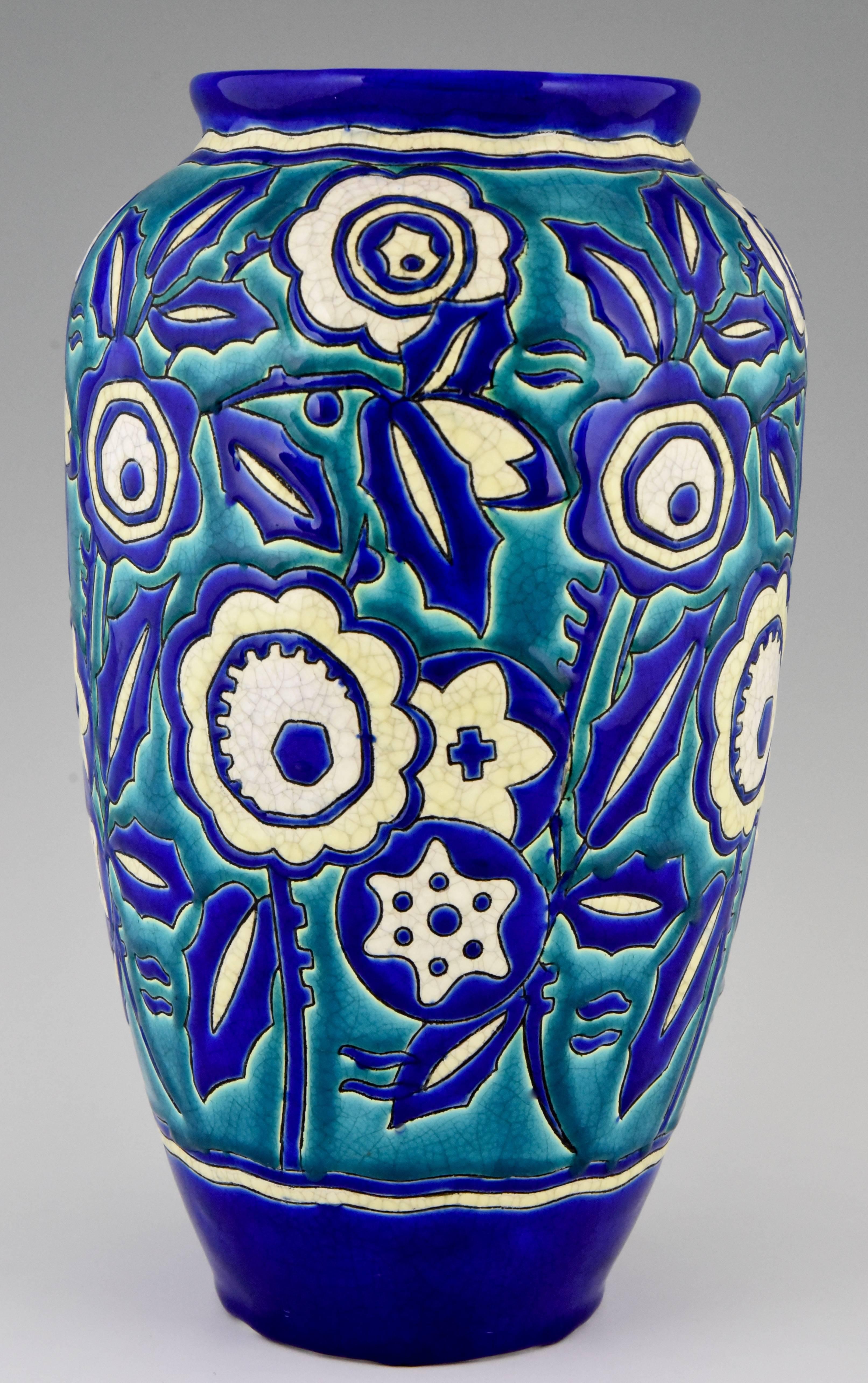 Colorful Art Deco craquelé vase by Keramis, Belgium.
With turquoise, blue and white craquelé flower pattern. 
 
Signature/ Marks: Keramis stamp. Numbered D1425 for the decor.
Style: Art Deco
Date: 1929
Material: Turquoise, blue and white