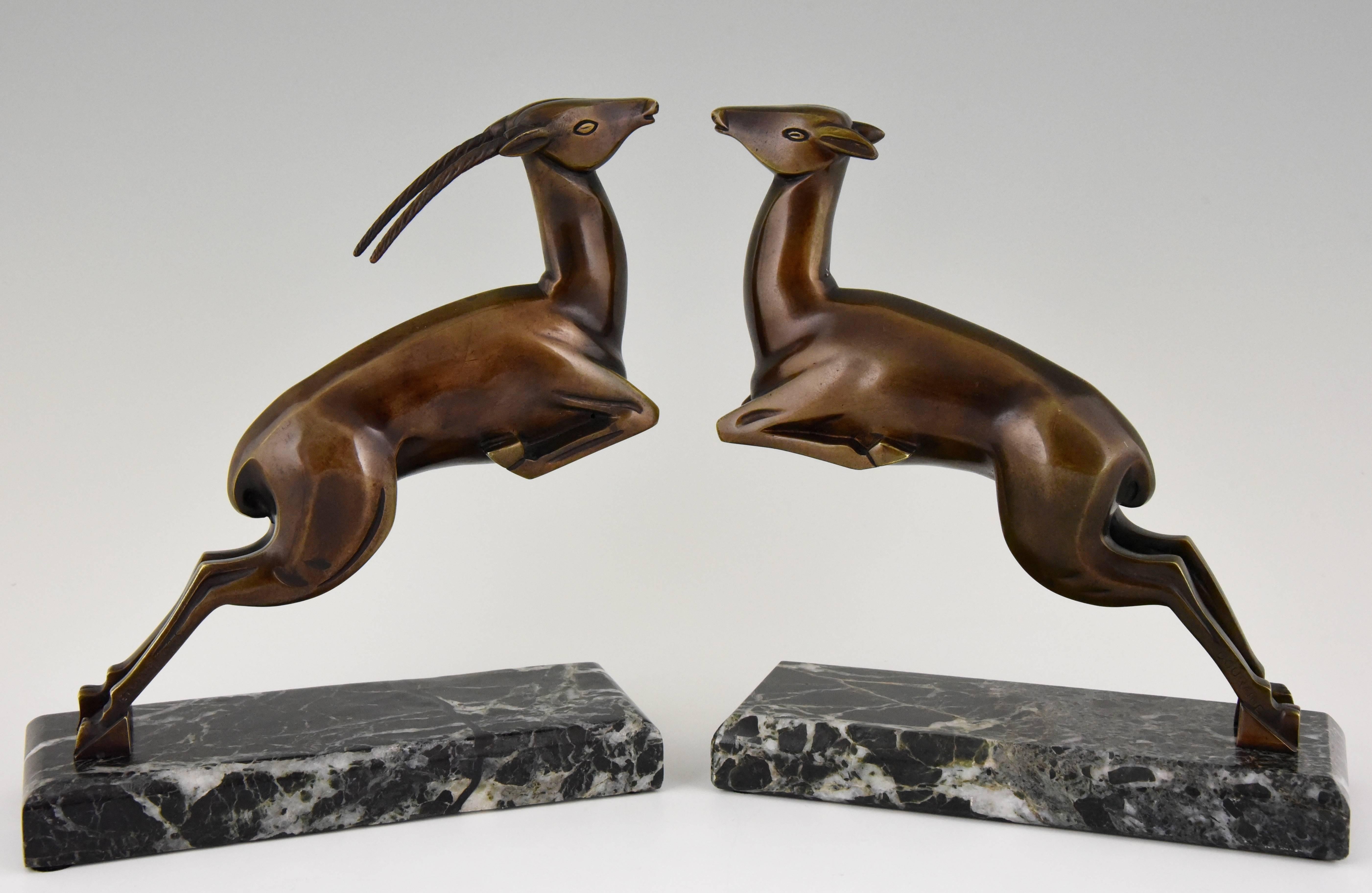 A pair of elegant French Art Deco bronze sculptural bookends with leaping gazelles on green marble bases by Marcel André Bouraine, 1886-1948. 

Artist/ Maker: Marcel Bouraine
Signature/ Marks: Bouraine, Etling Paris, founders’ signature.
Style: