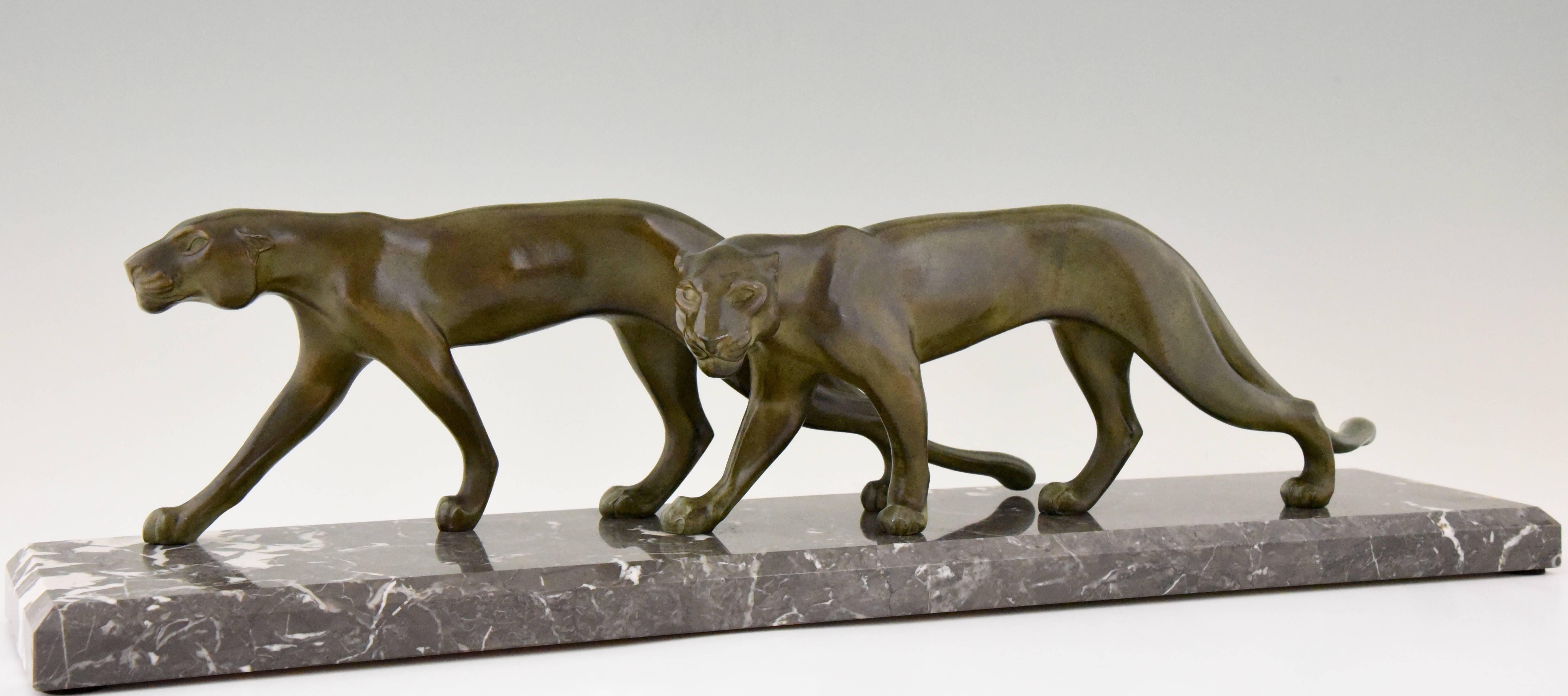 Stylish Art Deco sculpture of two walking panthers by the French artist M. Font.
Signed on the base. 

Style: Art Deco
Date: 1930
Material: Patinated art metal. Marble base.
Origin: France
Size: H 18 cm x L 70 cm. x W 14.5 cm.
H 7.1 inch x L