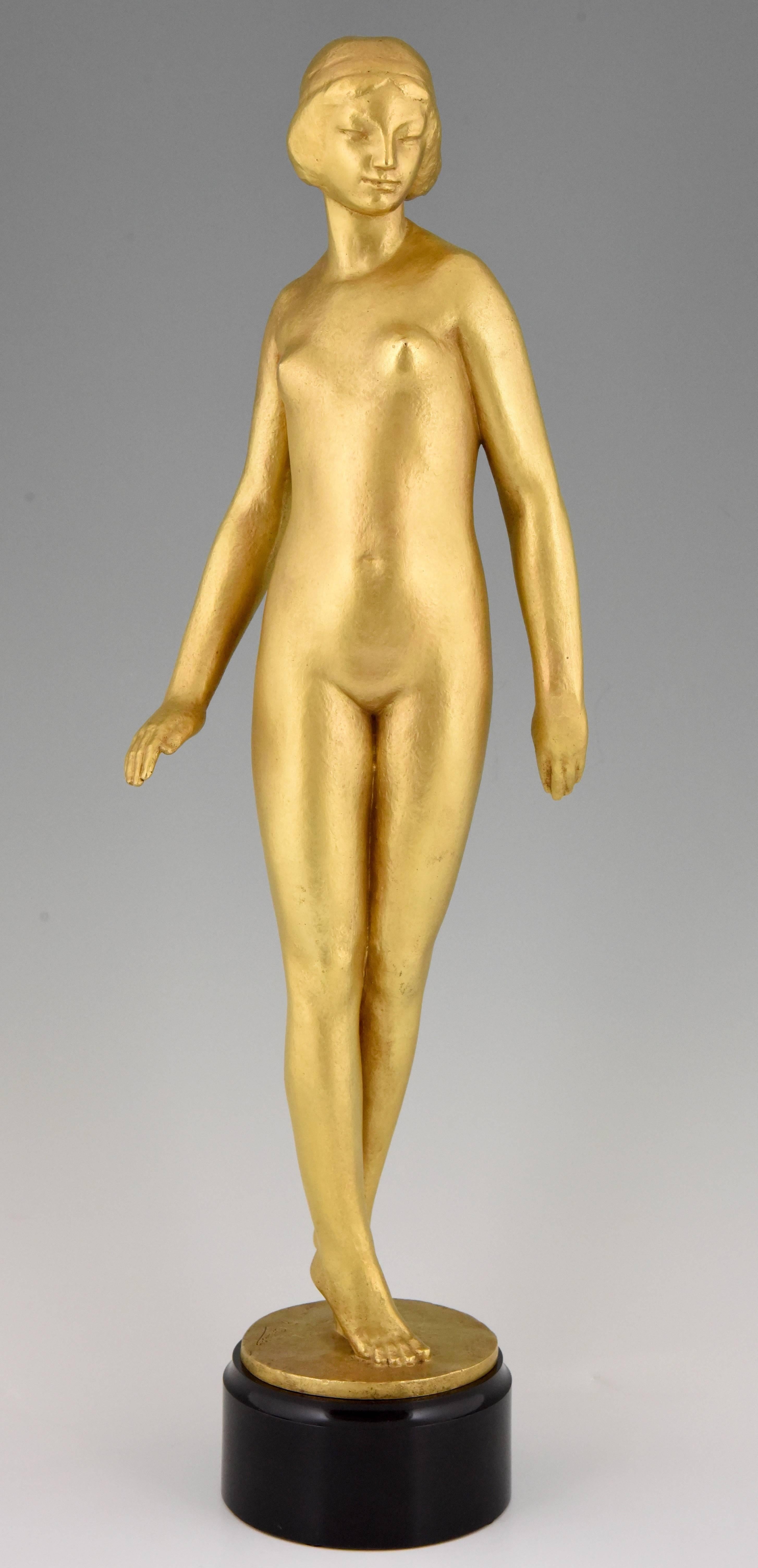 Beautiful typical French Art Deco sculpture of an elegant standing nude bather by Gaston Louis Joseph Contesse. This fine gilt bronze figurine has been cast by the Alex Rudier foundry in Paris.
The sculpture is 23 inch high and stands on a circular