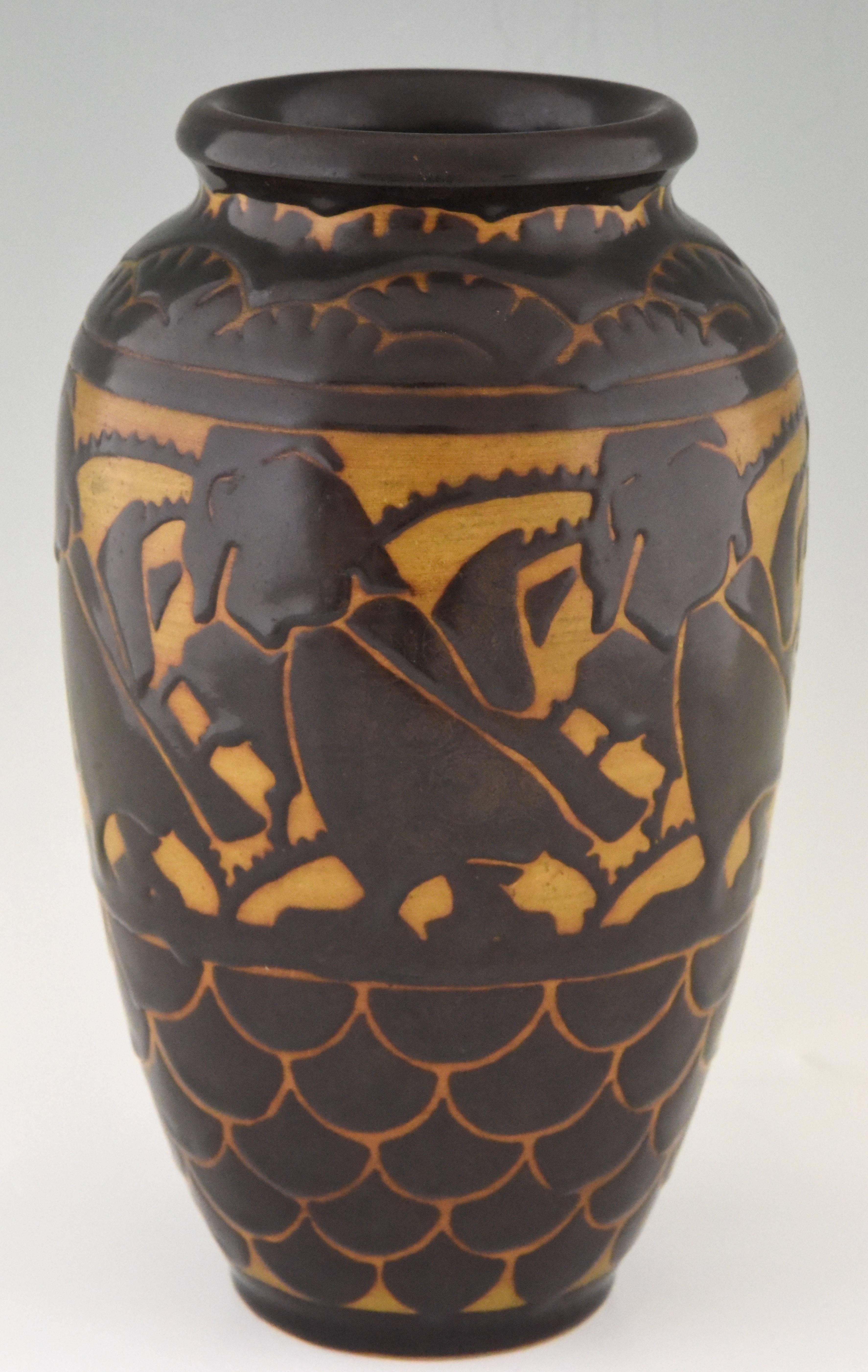 Art Deco ceramic vase with stylized birds.
Artist/ Maker: Charles Catteau, Keramis
Signature/ Marks: Ch Catteau, D 1026A, Keramis stamp.
Style: Art Deco
Date: 1925
Material: Grès, Ceramics.
Origin: Belgium
Size: H 31 cm. x W 19 cm x L 19