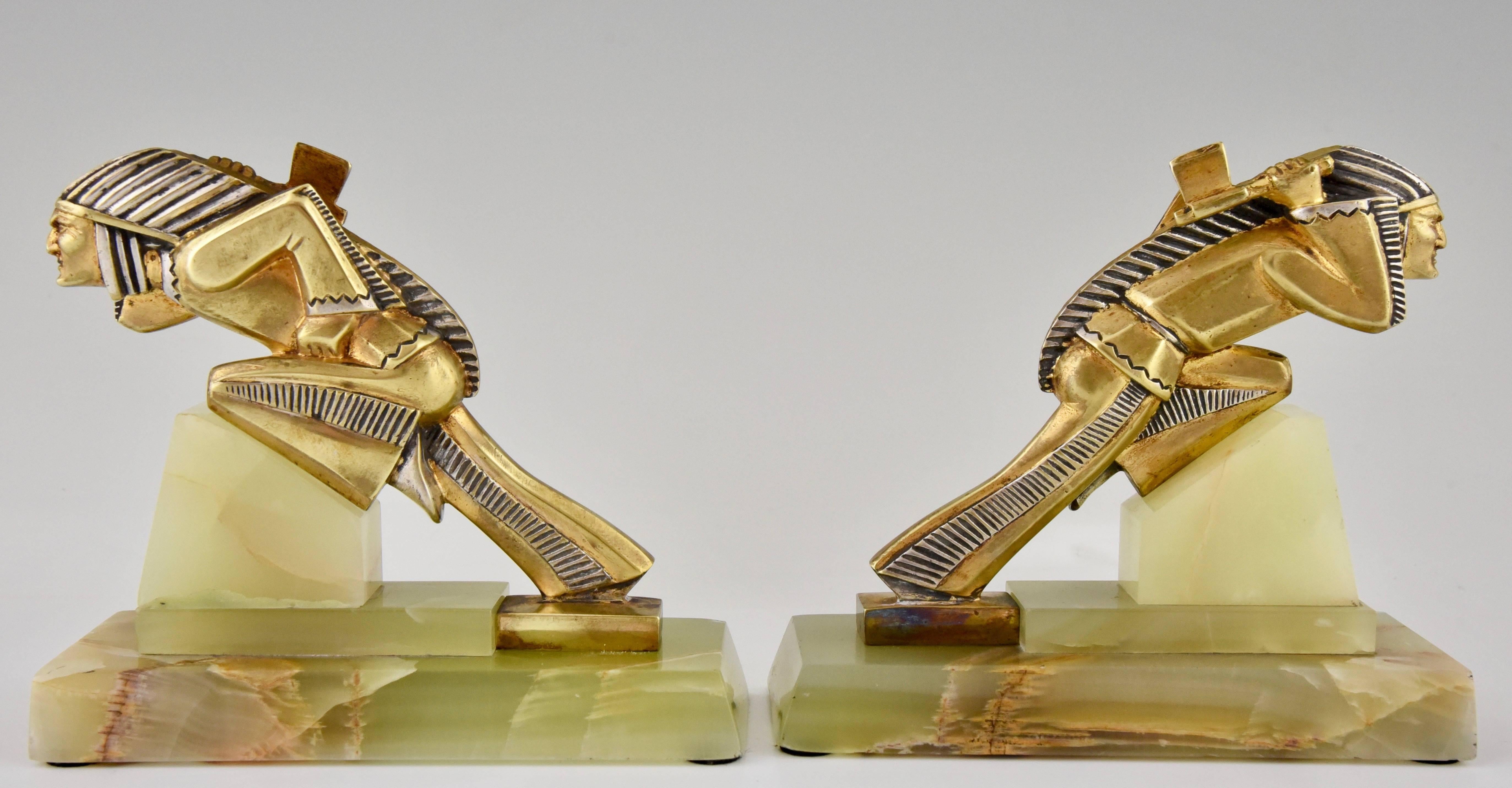 A pair of Indian Art Deco bronze bookends.
Artist/ Maker: Gibert
Signature/ Marks: Unsigned
Style: Art Deco
Date: 1930
Material: Gilt and silvered bronze.?Onyx base.
Origin: France
Size: H. 13.5 cm x L. 15.3 cm. x W. 6.7 cm. ? 
H. 5.3 inch x