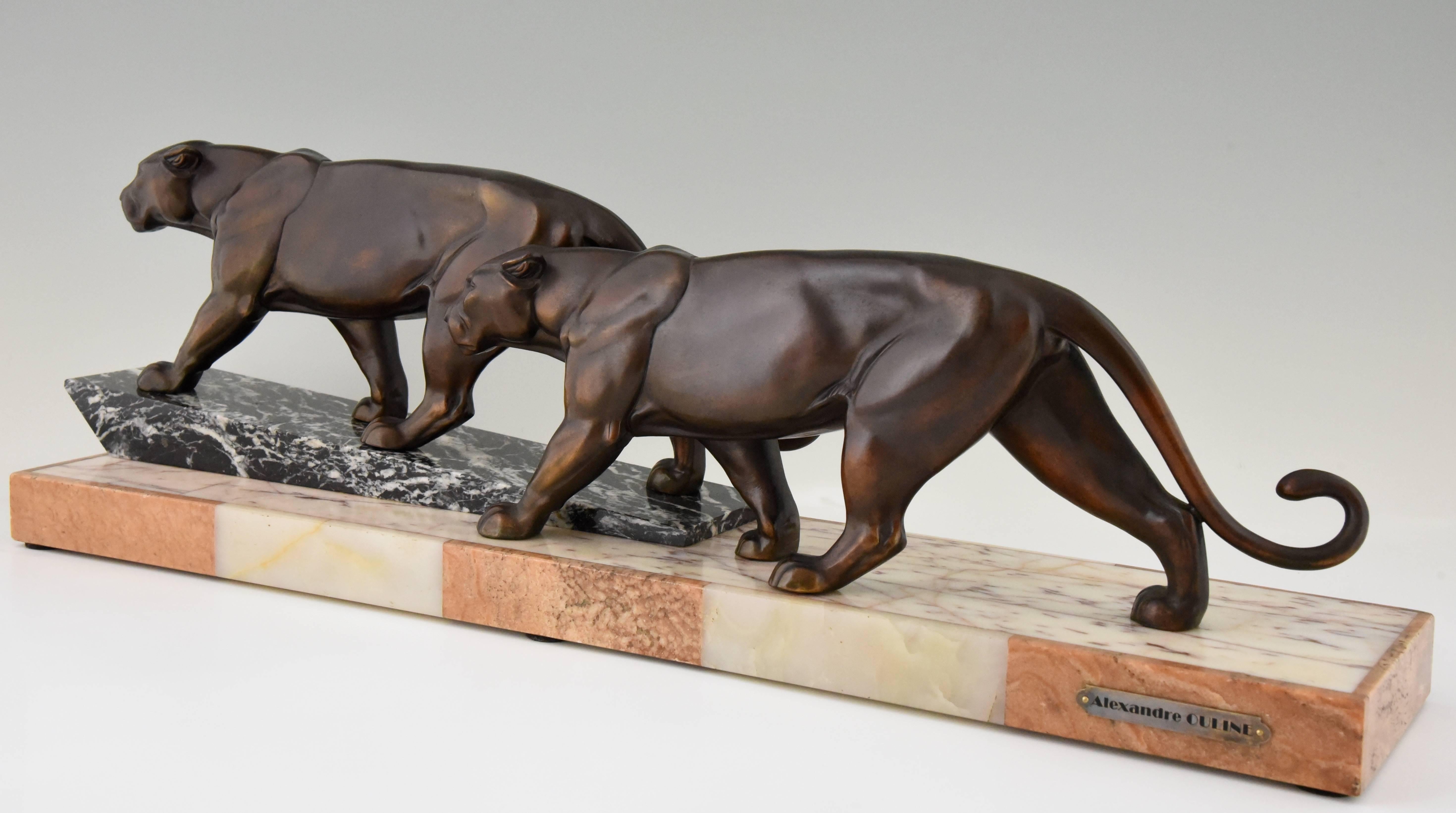 French Art Deco sculpture of two walking panthers on marble base. 
Signature / marks: Alexandre Ouline.
Style: Art Deco.
Date: 1925
Material: Art metal, brown patina with shades. Marble base with onyx inlay.
Origin: France
Size: L. 71.5 cm. x
