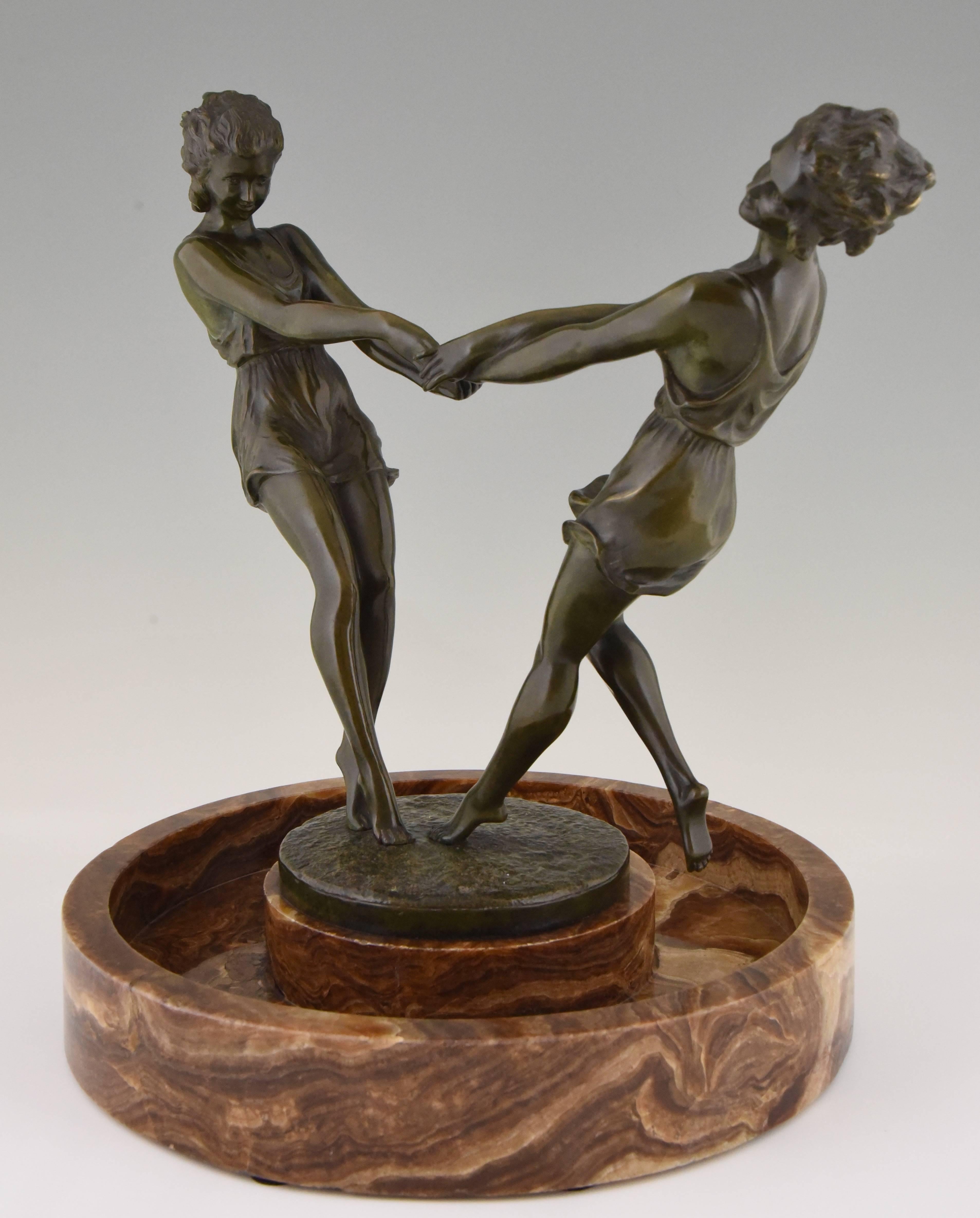 Whirling, an impressive circular marble centrepiece with a bronze sculpture of two dancing girls holding hands by the French artist Andre Gilbert.
Signature/ marks: Andre Gilbert
Style: Art Deco
Date: 1925
Material: Bronze with green patina.