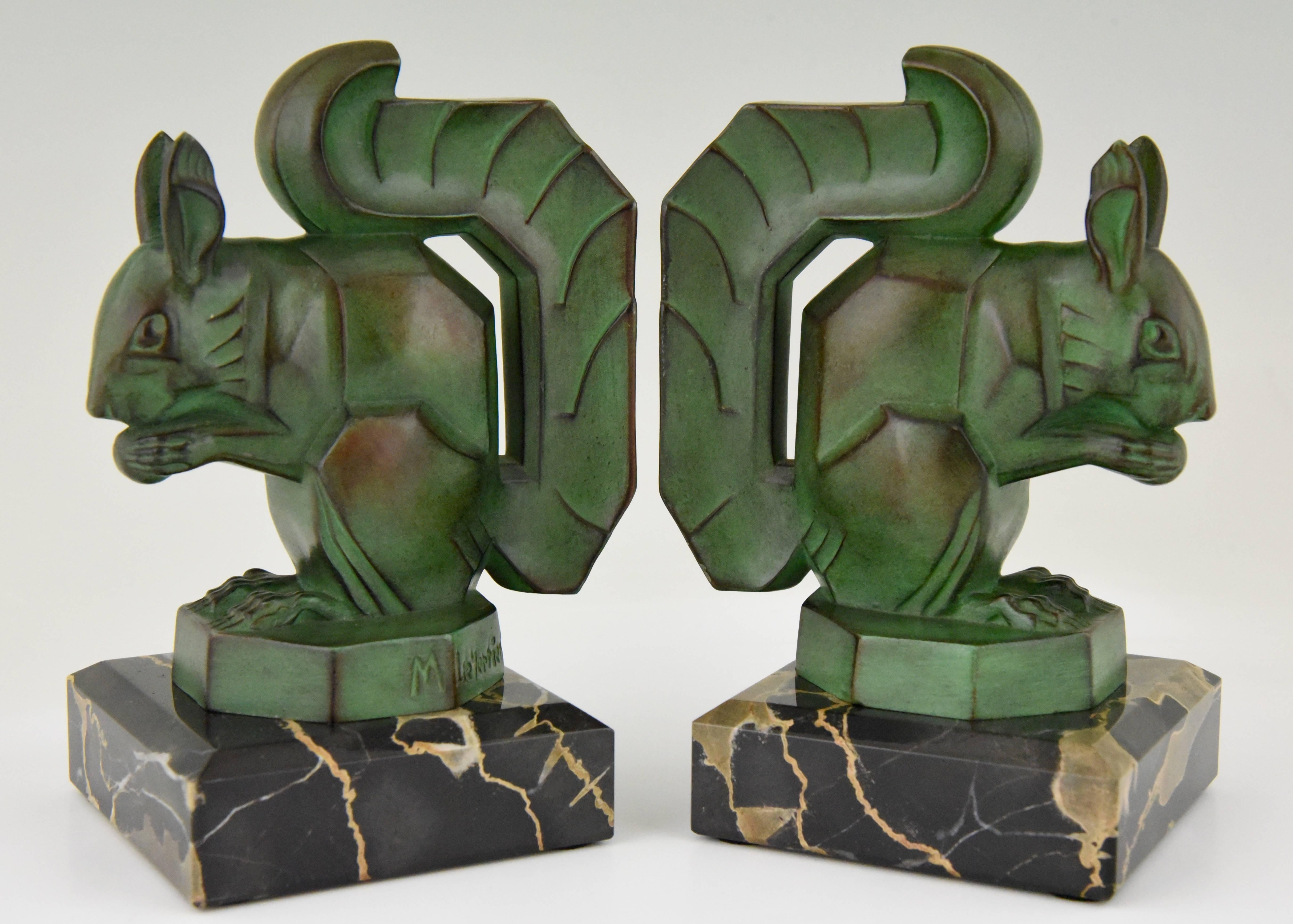 Lovely pair of squirrel bookends with typical Art Deco lines. Patinated Art metal on a Portor marble base. Signed by the well know sculptor Max Le Verrier. 
Signature/ Marks: M. Le Verrier.
Style: Art Deco
Date: 1925-1930
Material: Patinated Art