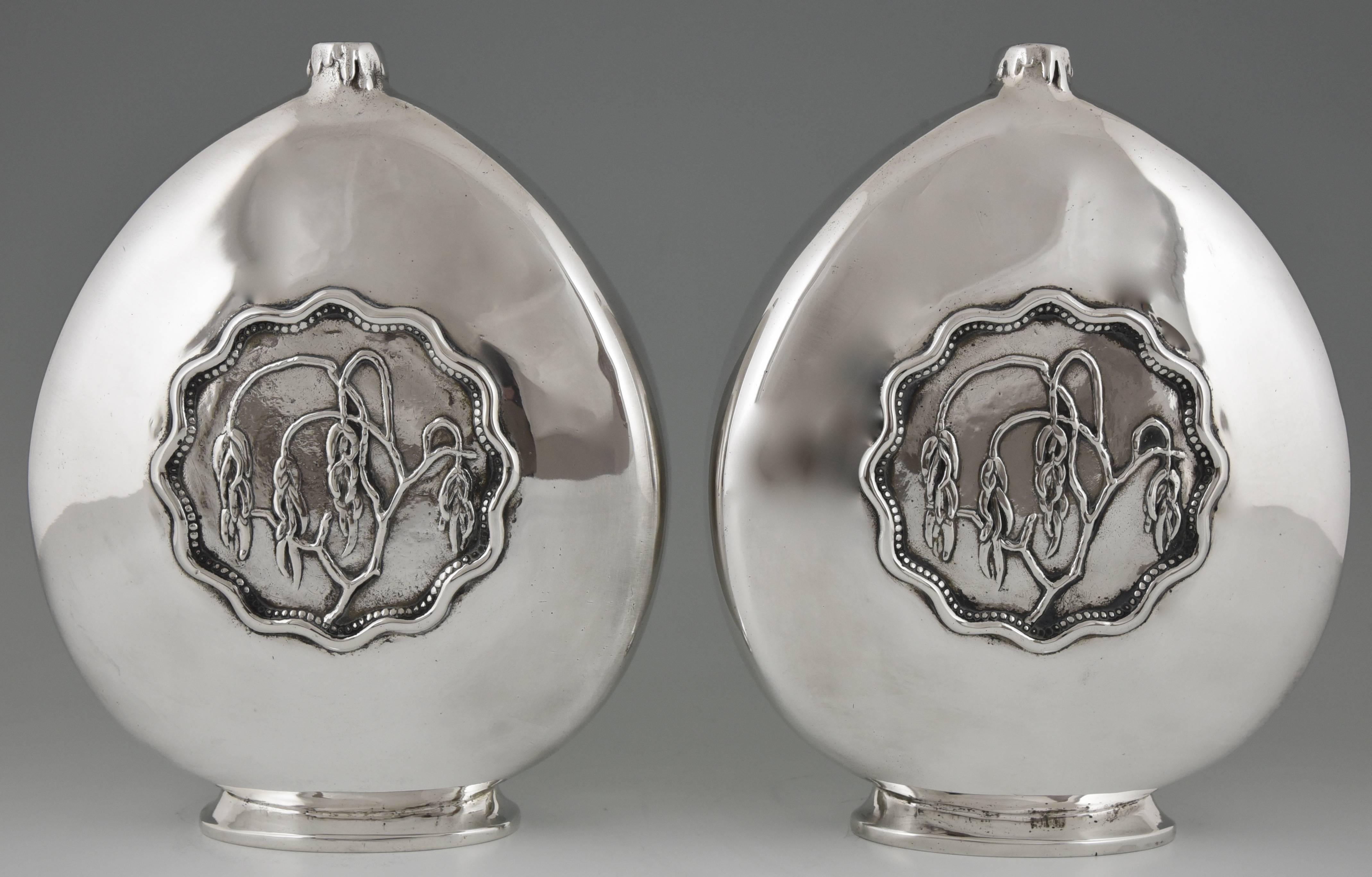 A pair of silvered bronze Art Deco vases with a decoration of branches in relief. By Georges Poitvin. Famous for his car mascots and worked for the Hermes company.  He received several award for his work. 
Signature & Marks:  G. Poitvin.  Stamped