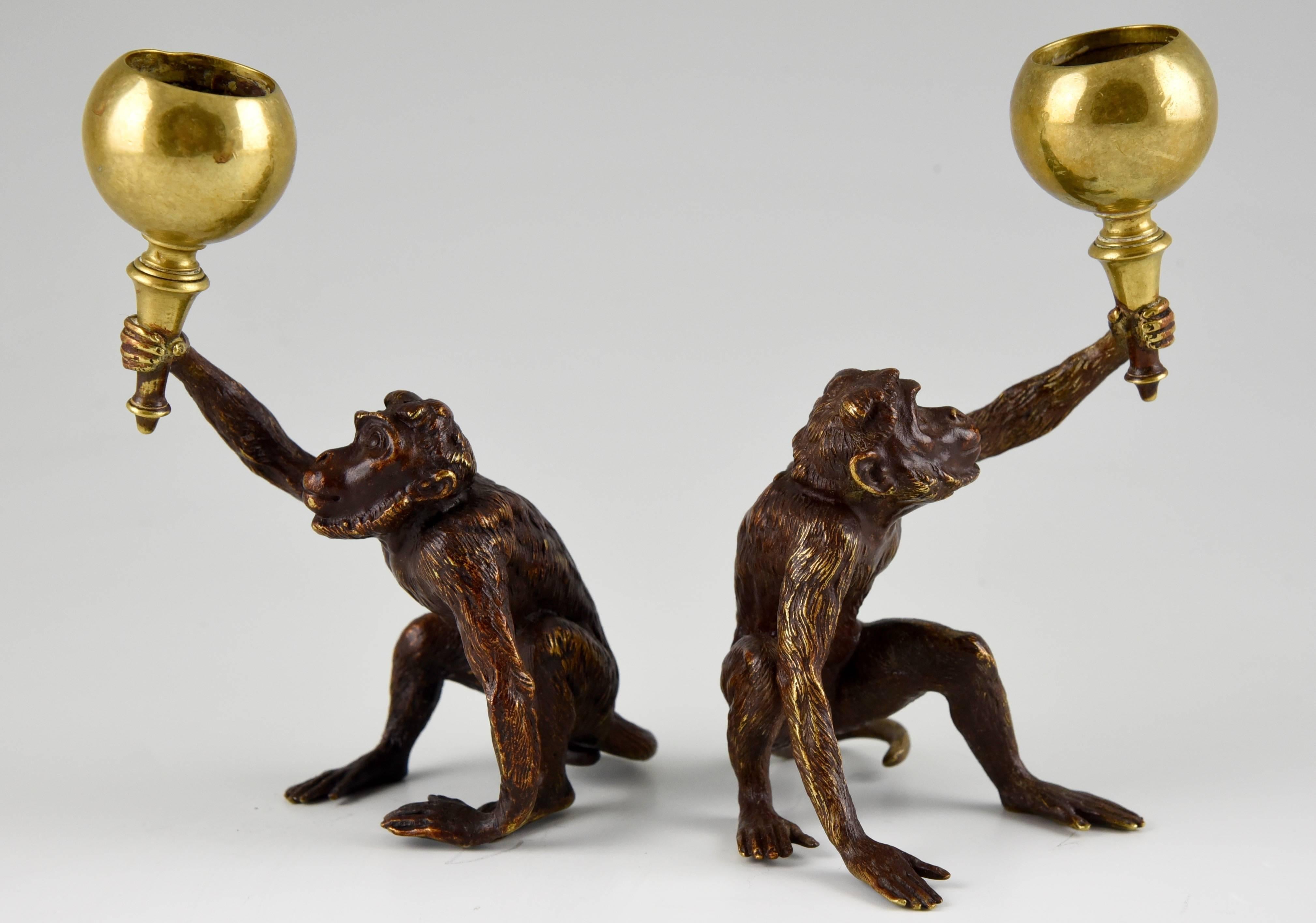 A pair of Vienna bronze F. Bergmann monkey candleholders.
Artist: F Bergmann
Signature and Marks: Geschutzt. FB
		
Date:  1900.			
Material:  Cold painted bronze. 
Origin:  Vienna, Austria. 			

Size of one: 
H.  5.5 inch. x W. 2.9 cm. x L.